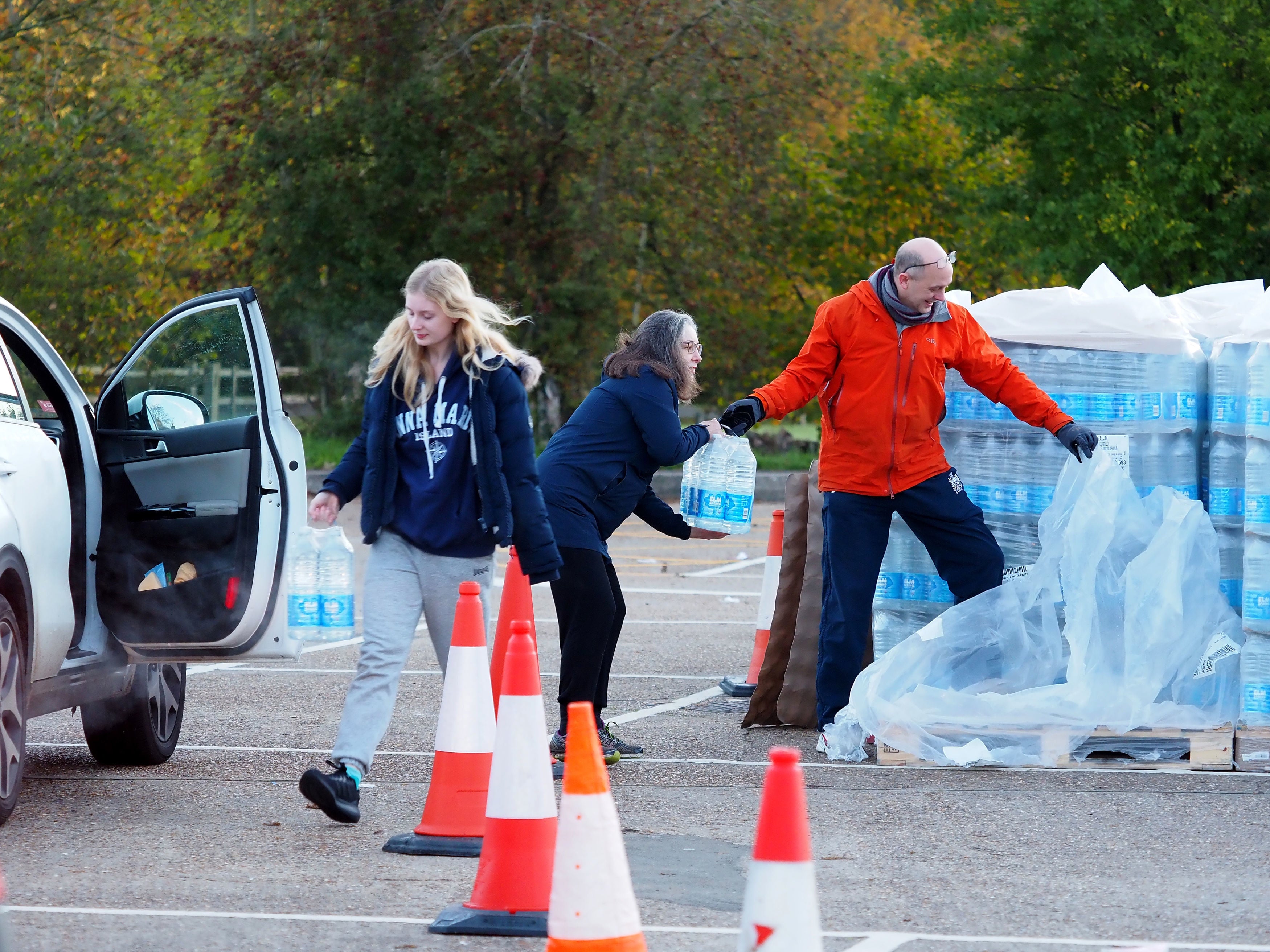 Local residents collect bottles of water in Godalming, Surrey, as almost 12,000 people were without running water in after Storm Ciaran