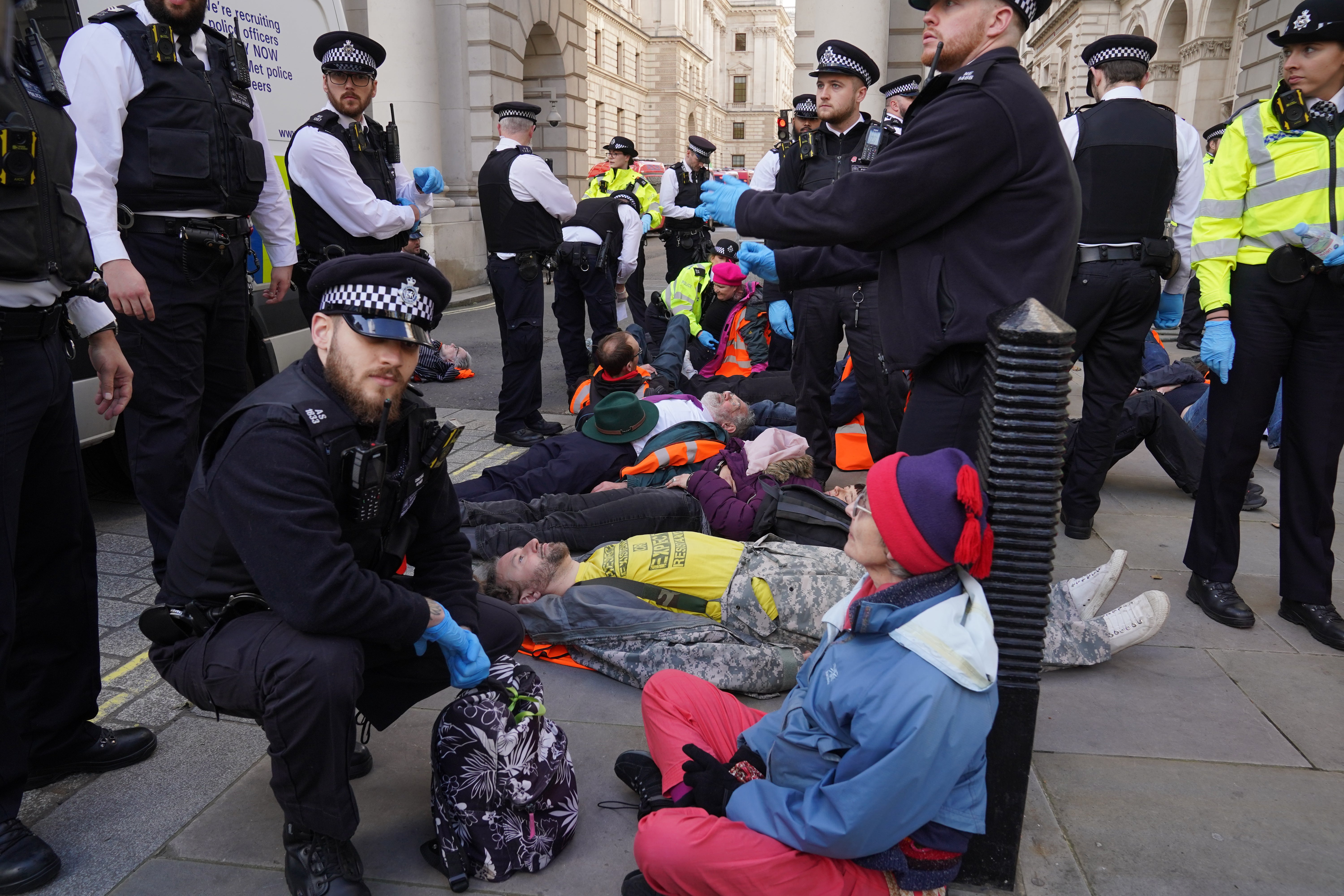 Officers from the Metropolitan Police surround Just Stop Oil protesters