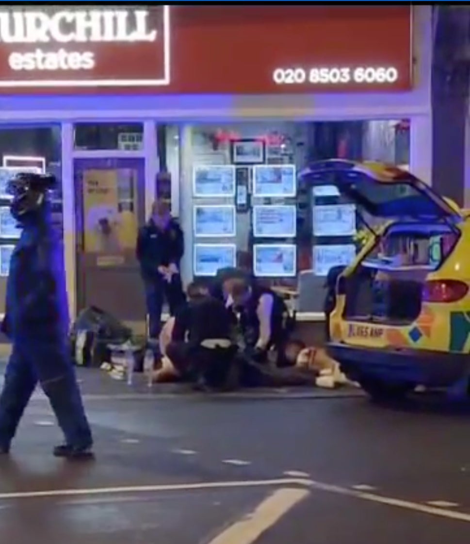 Officers attend to the injured men in Waltham Forest on Sunday