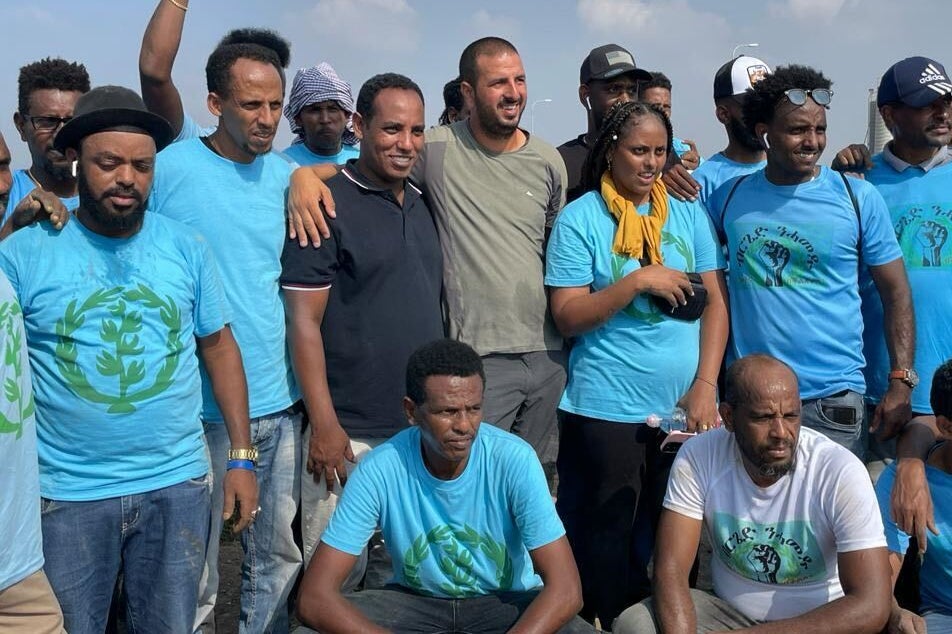 Gadi Yevarkan, centre left in navy shirt, next to farmer Barak Elgahi and some of the Eritreans seeking to help