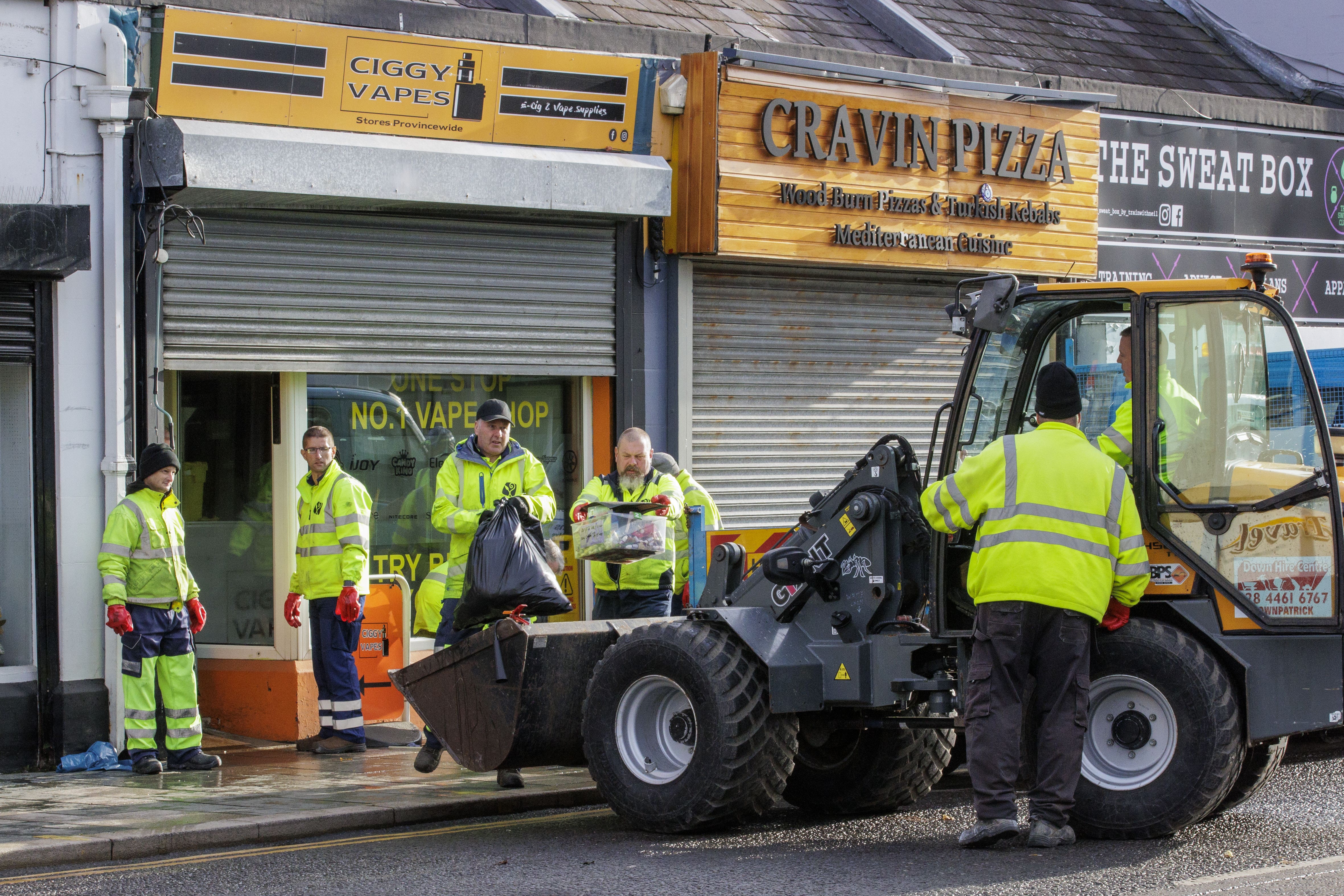 Council workers from Newry, Mourne and Down District Council help clean up flood-stricken Downpatrick, Co Down (Liam McBurney/PA)