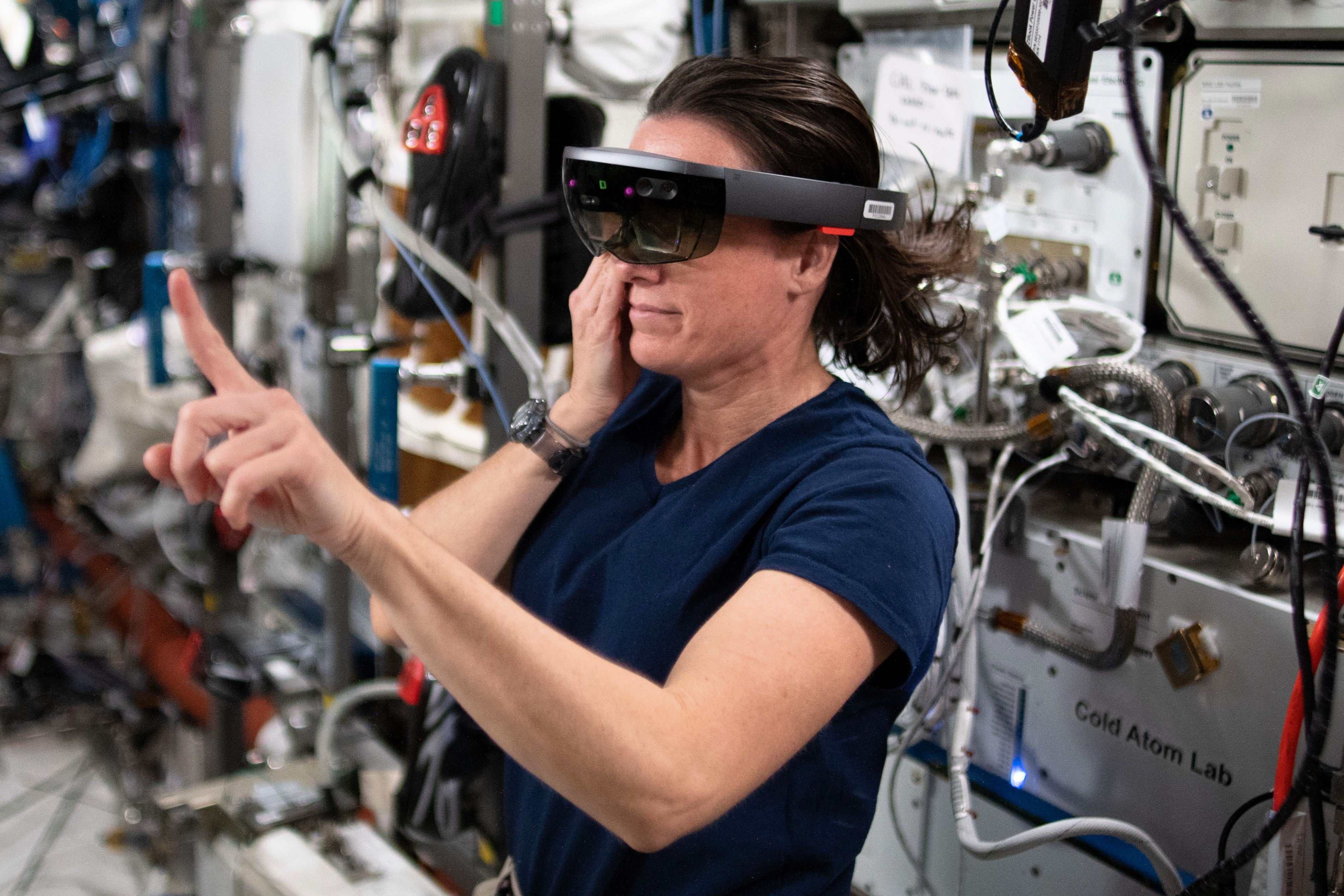 Nasa astronaut Megan McArthur wears a HoloLens VR headset to test an augmented reality application during Expedition 65