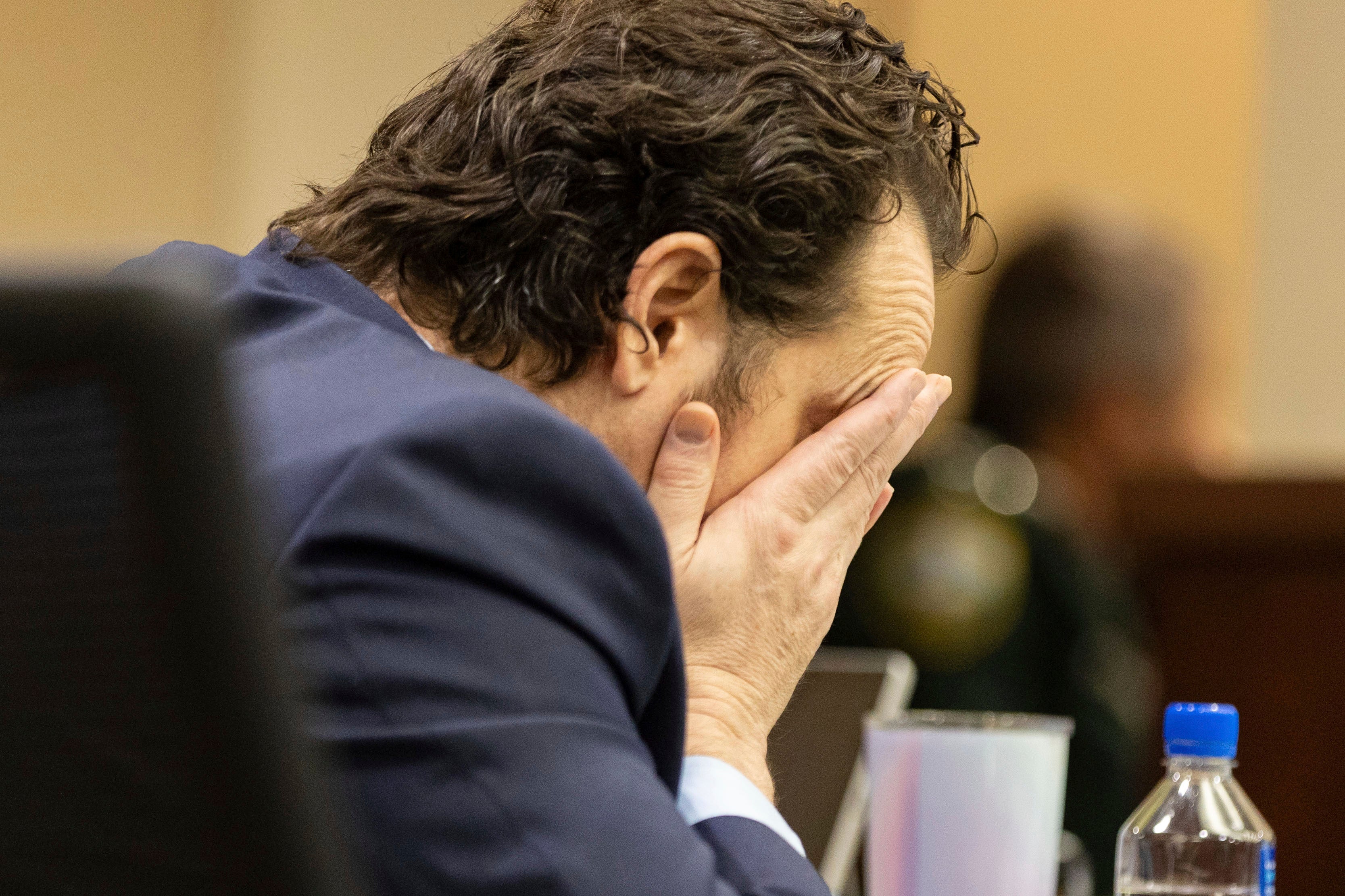 Charlie Adelson rubs his face as he waits for his verdict in his murder trial