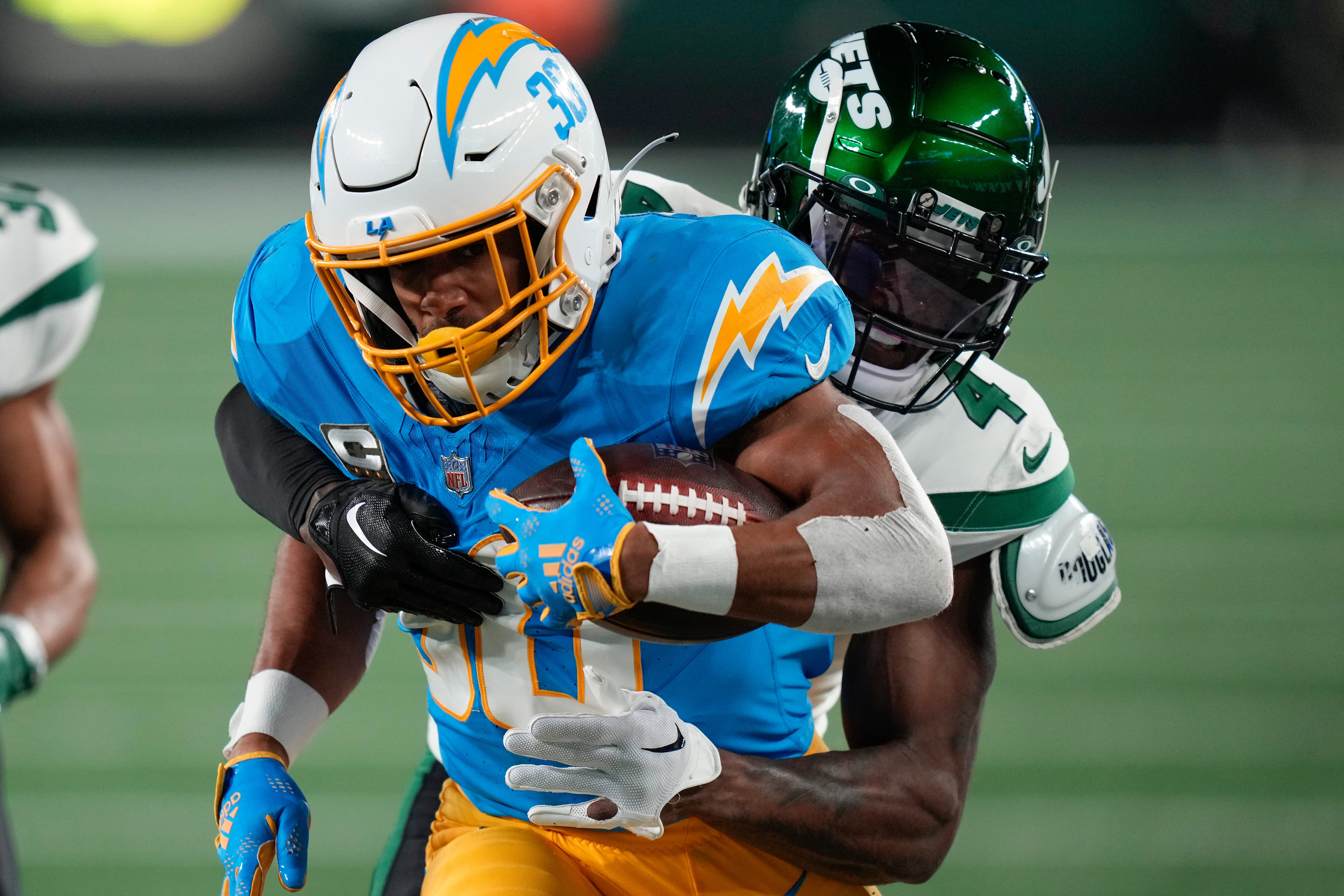 Los Angeles Chargers running back Austin Ekeler carries the ball against New York Jets cornerback DJ Reed (Seth Wenig/AP)