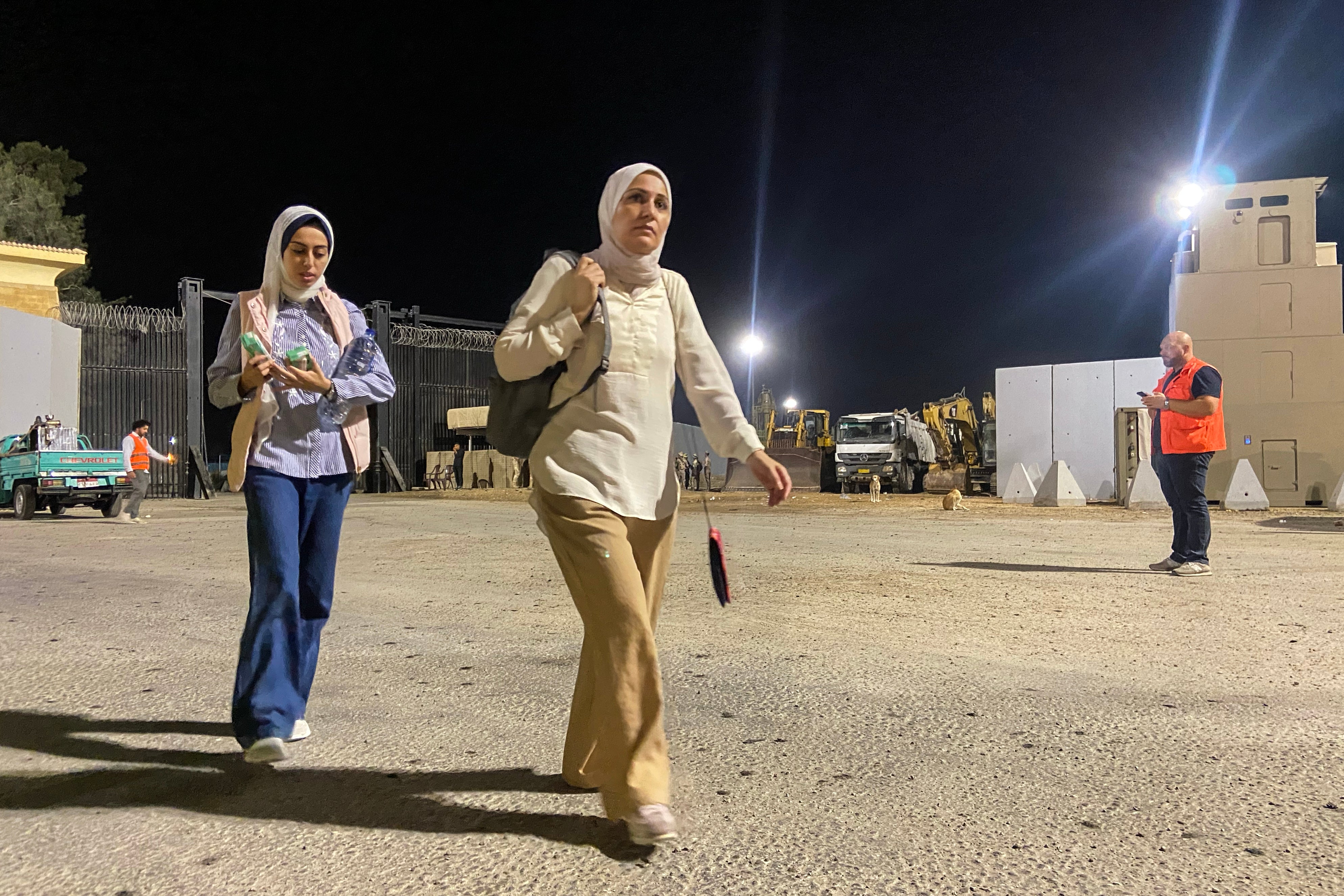 A woman walks after crossing on the Egyptian side of the Rafah border crossing with the Gaza Strip