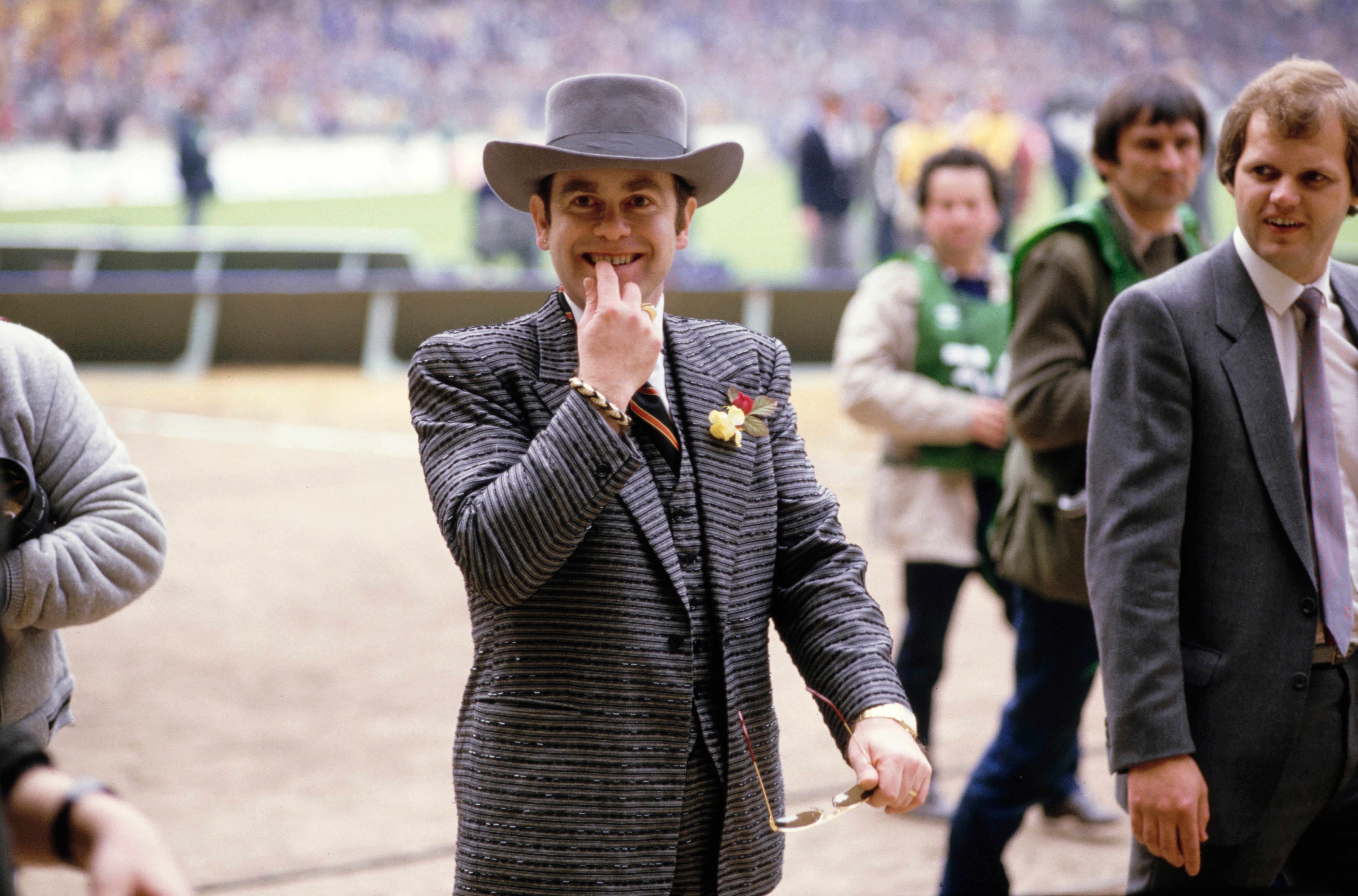 Elton John gestures to fans before the FA Cup final between Everton and Watford at Wembley Stadium on 19 May 1984