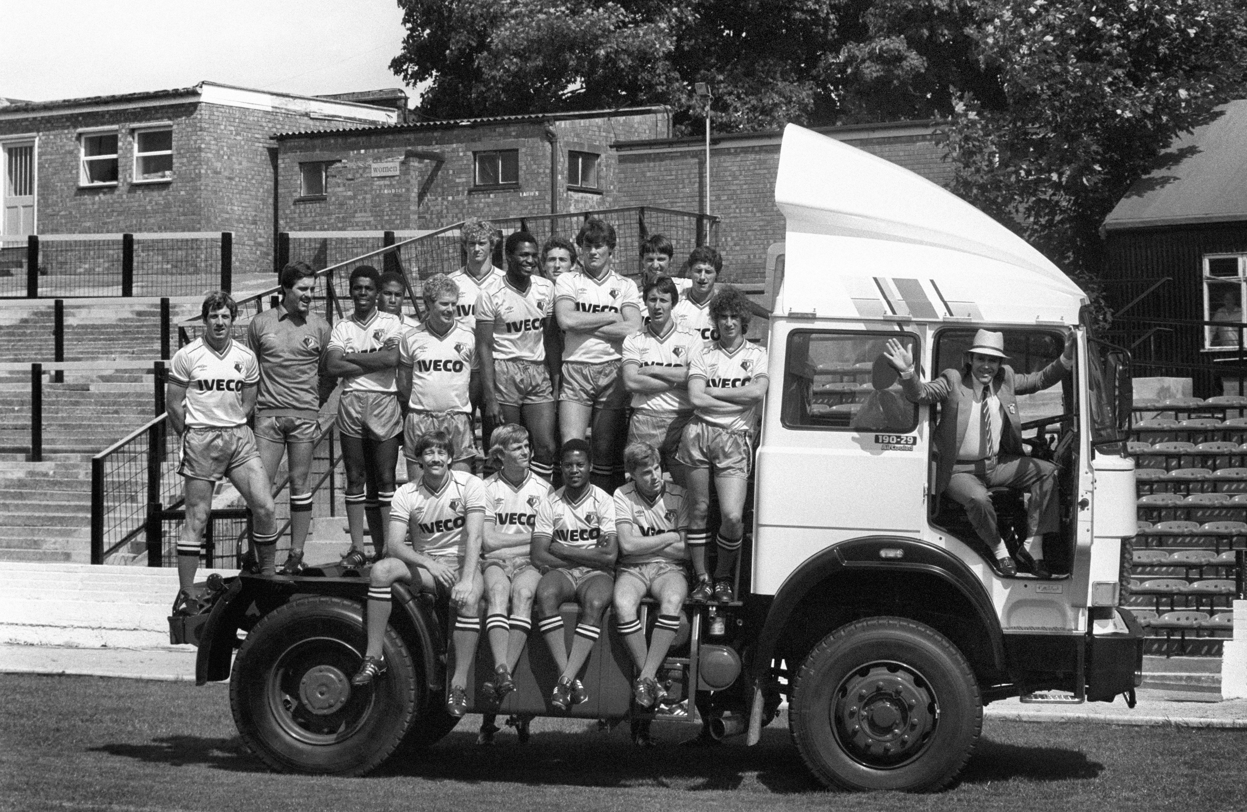 Watford chair Elton John at the wheel with his first team squad in their new shirts, which carried the name of truck and bus giant Iveco