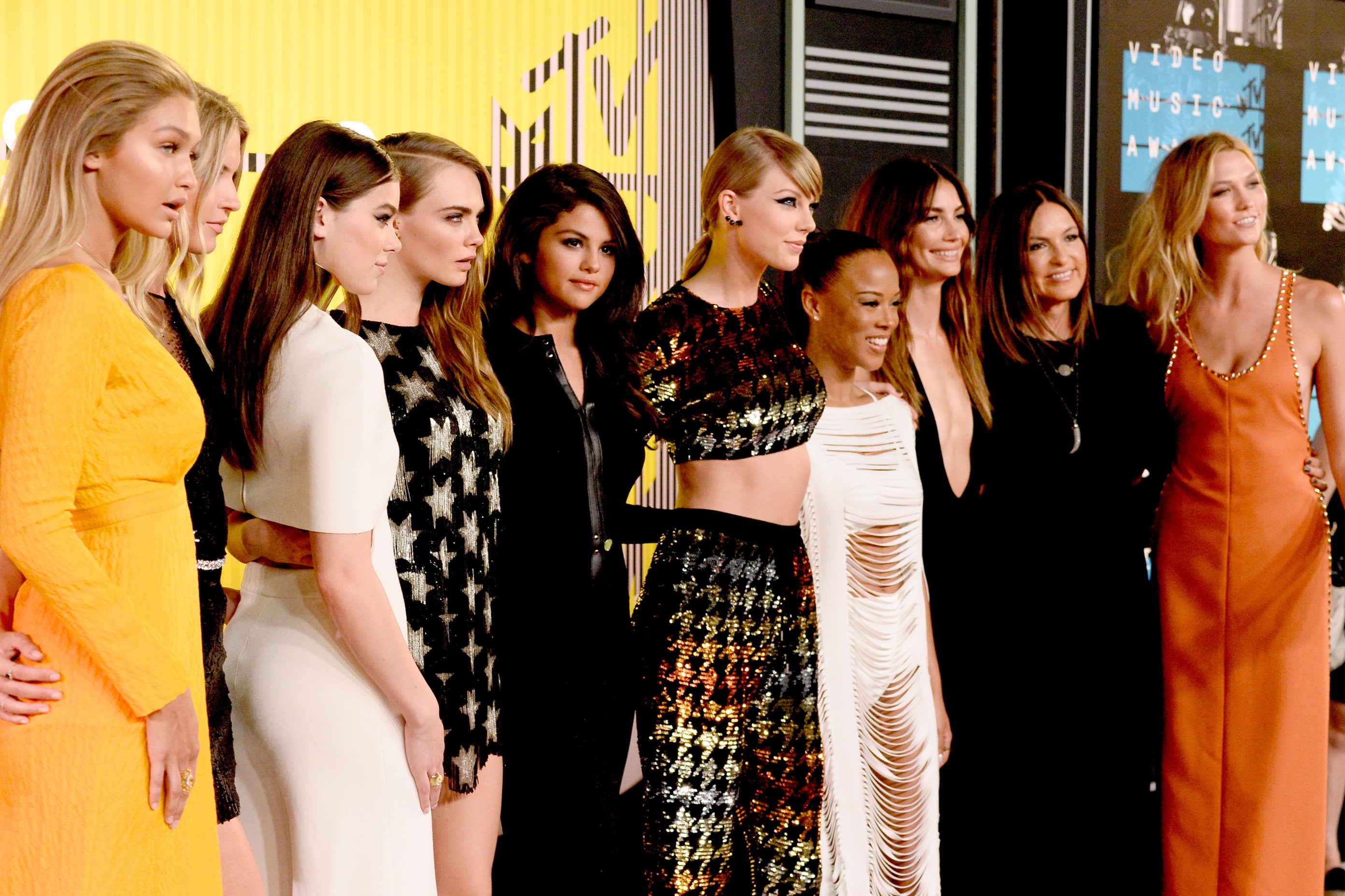 Please welcome to the stage...: Swift is flanked by (deep breath) Gigi Hadid, Martha Hunt, Hailee Steinfeld, Cara Delevingne, Selena Gomez, Serayah, Lily Aldridge, Mariska Hargitay and Karlie Kloss at the 2015 MTV VMAs