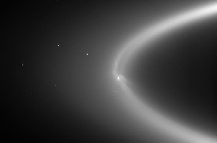 NASA image of Enceladus within the E-ring in orbit around Saturn