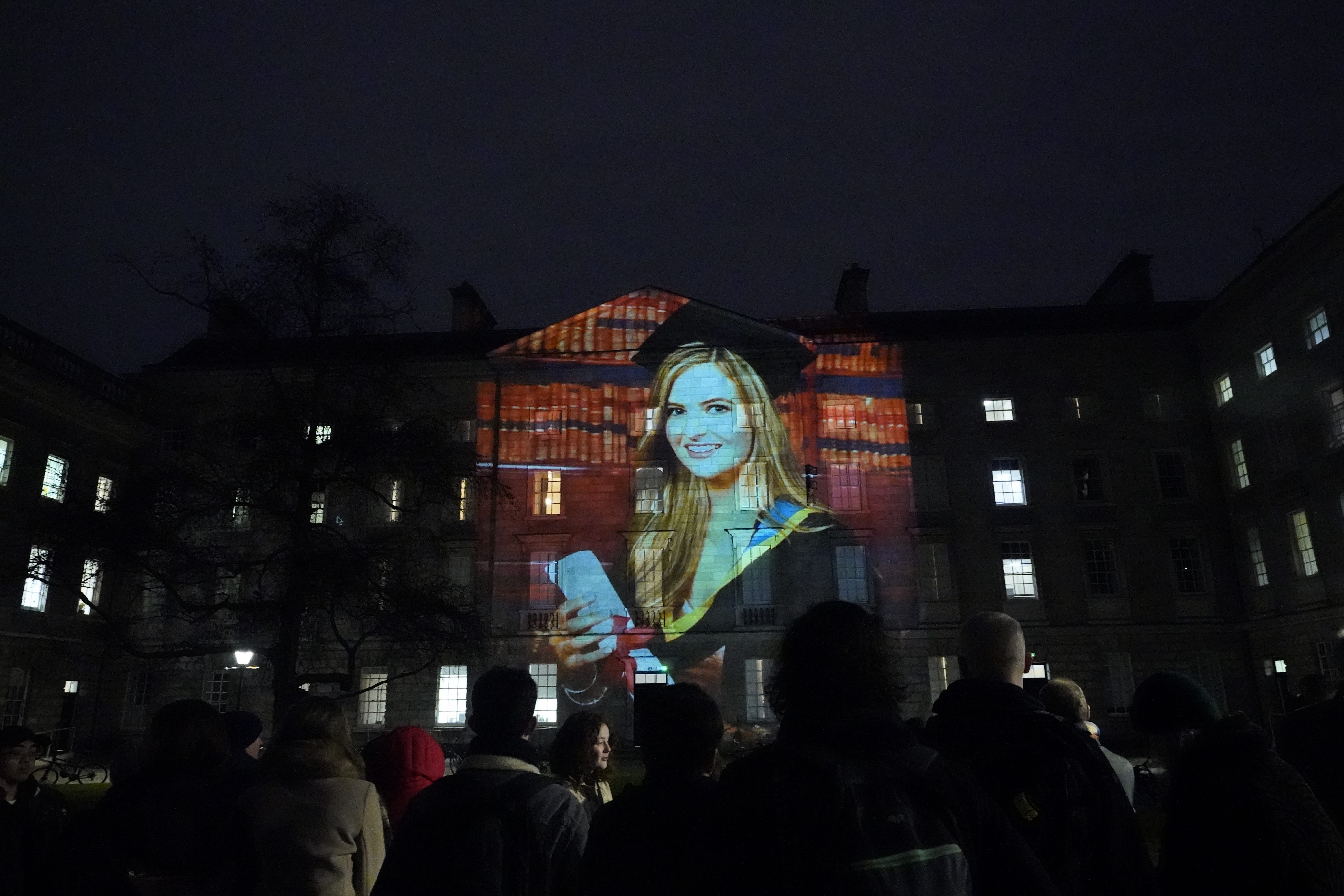 Crowds look at a projection of murdered teacher Ashling Murphy on the walls of Trinity College Dublin (Niall Carson/PA)