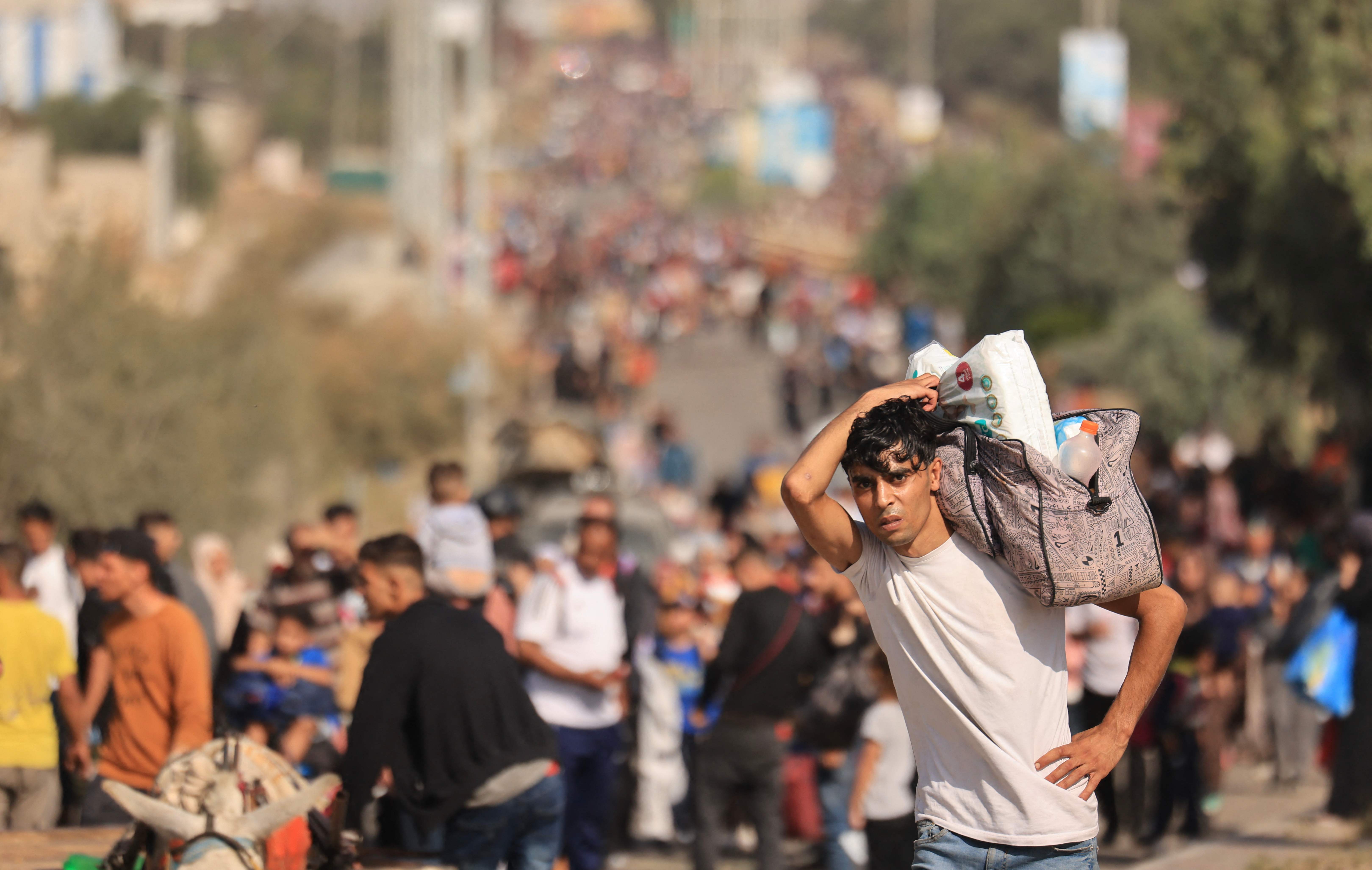 A Palestinian man carries his belongings on 9 November