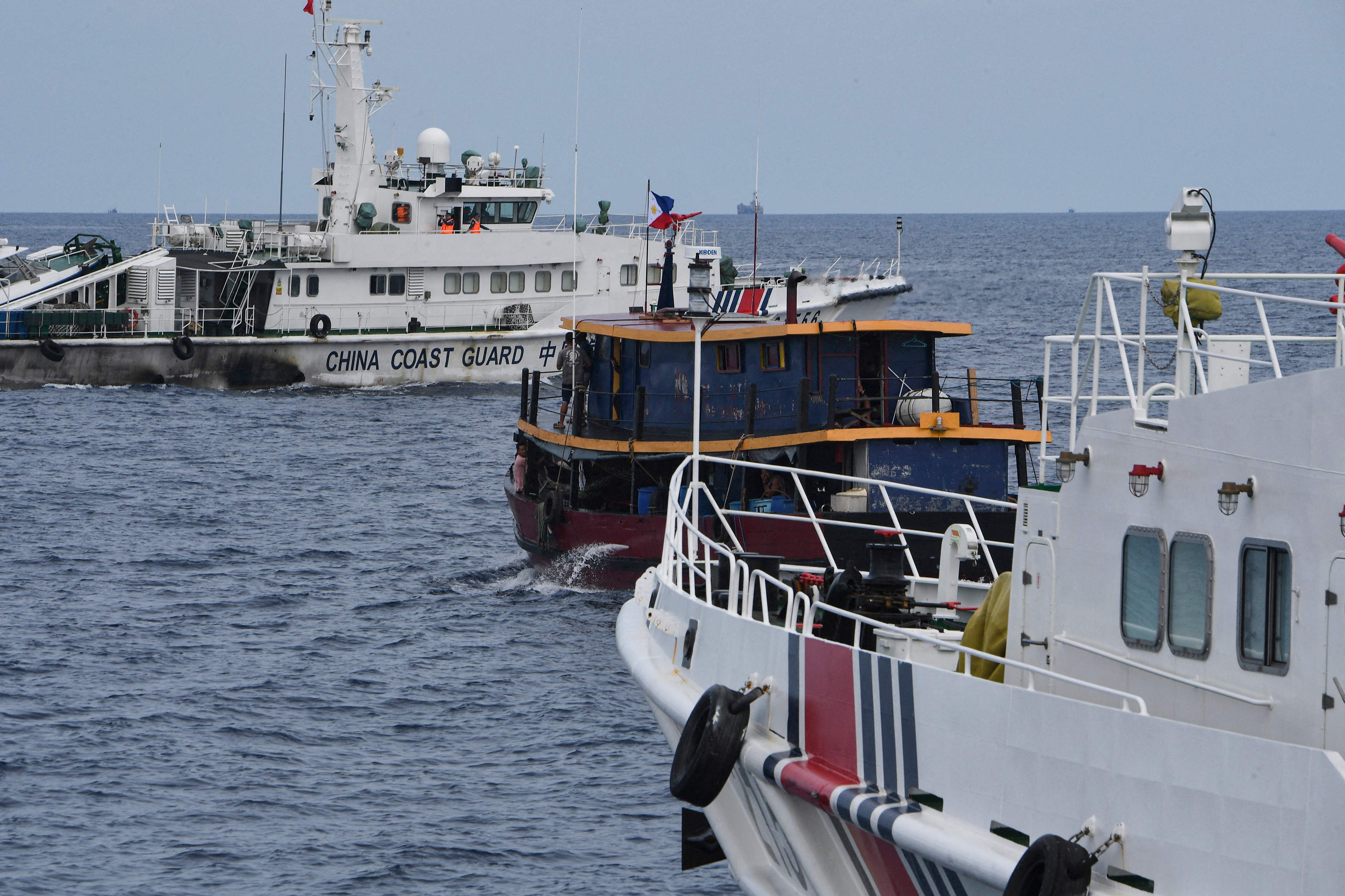 File Chinese coast guard ships and a corral a Philippine civilian boat chartered by the Philippine navy to deliver supplies to Philippine navy ship BRP Sierra Madre in the disputed South China Sea, on 22 August 2023