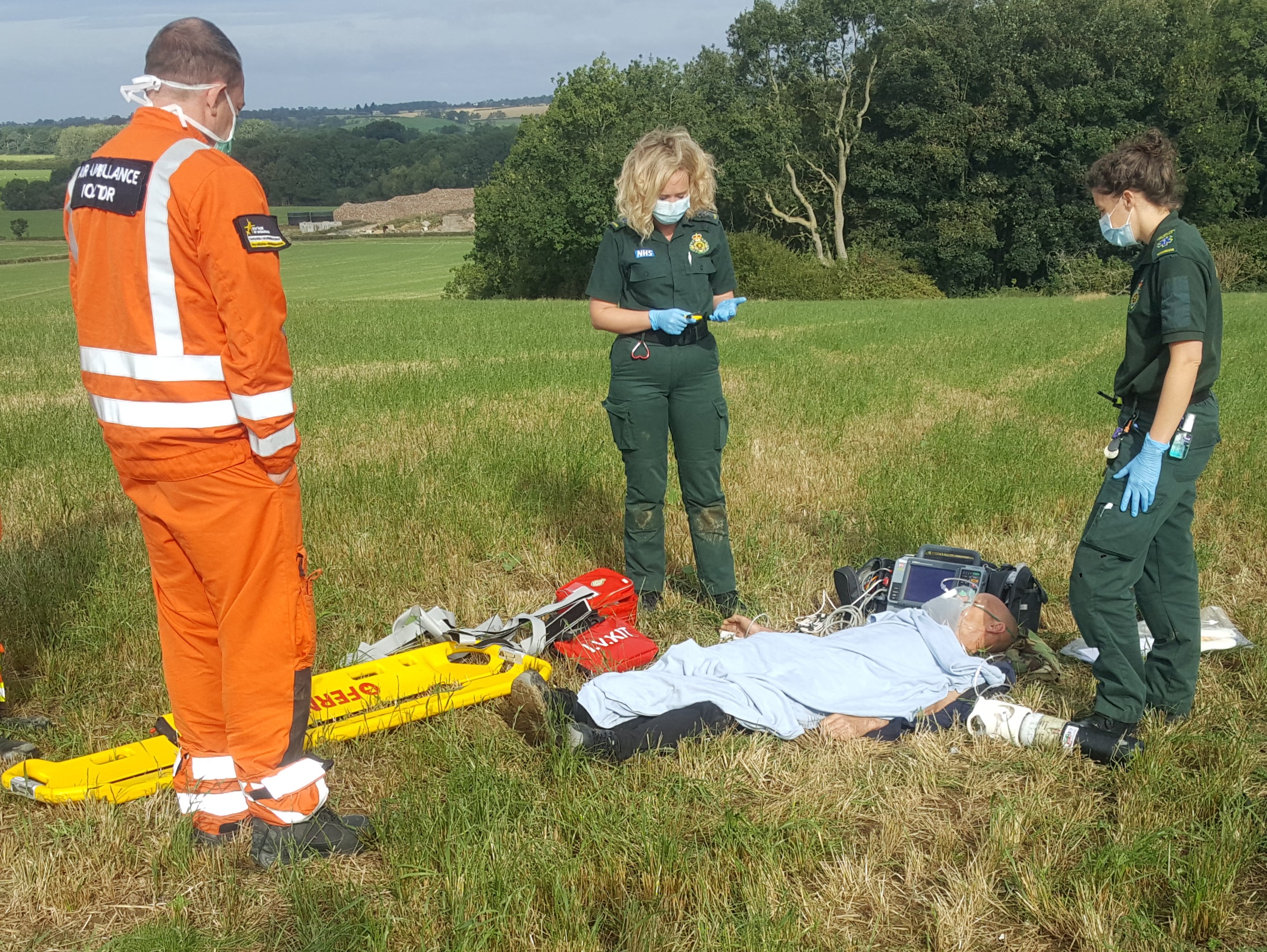 Paramedics put Mel Broughton on a stretcher to airlift him to hospital