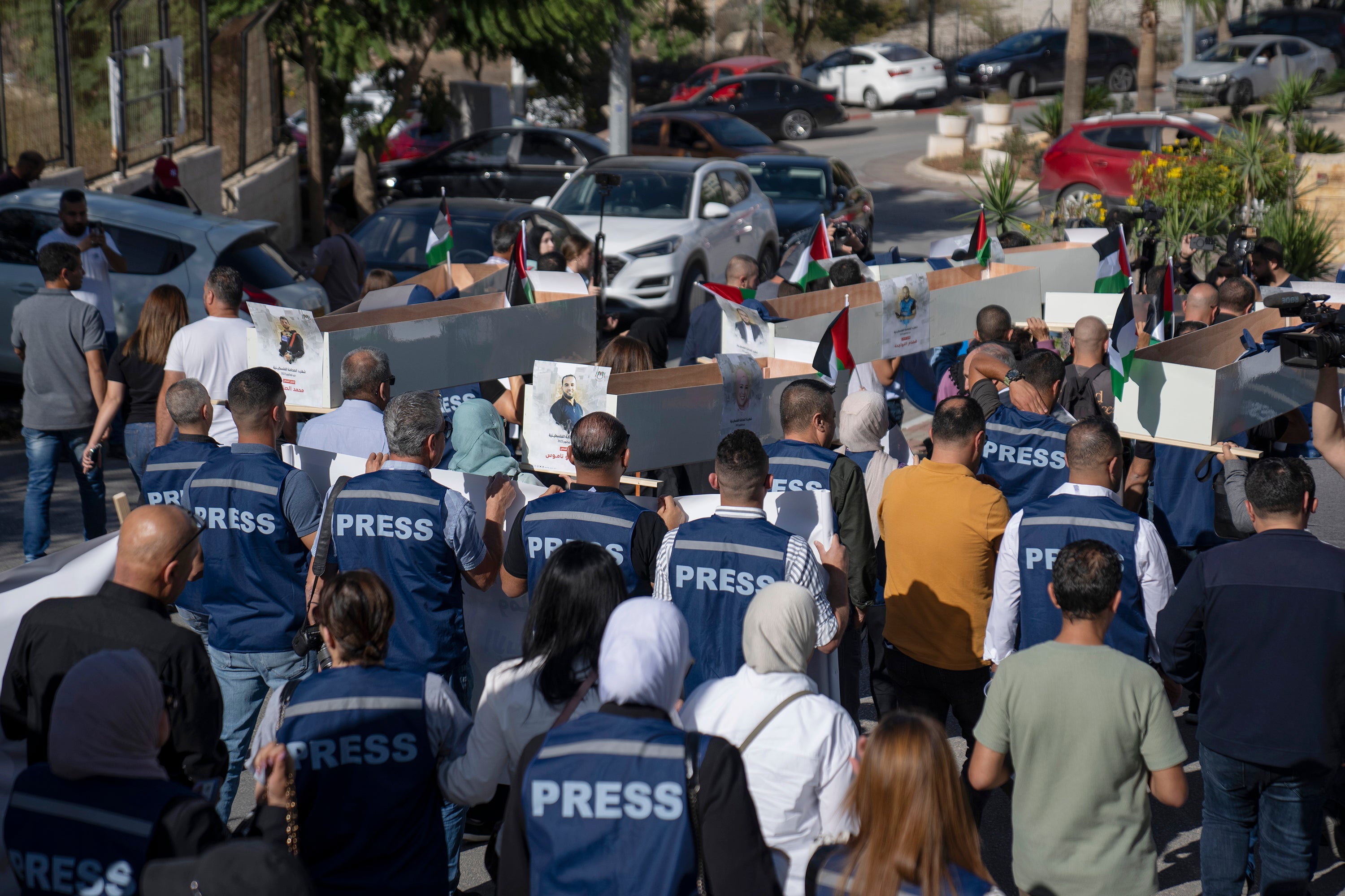 Palestinian journalists carry mock coffins of Palestinian journalists who were killed in Gaza.