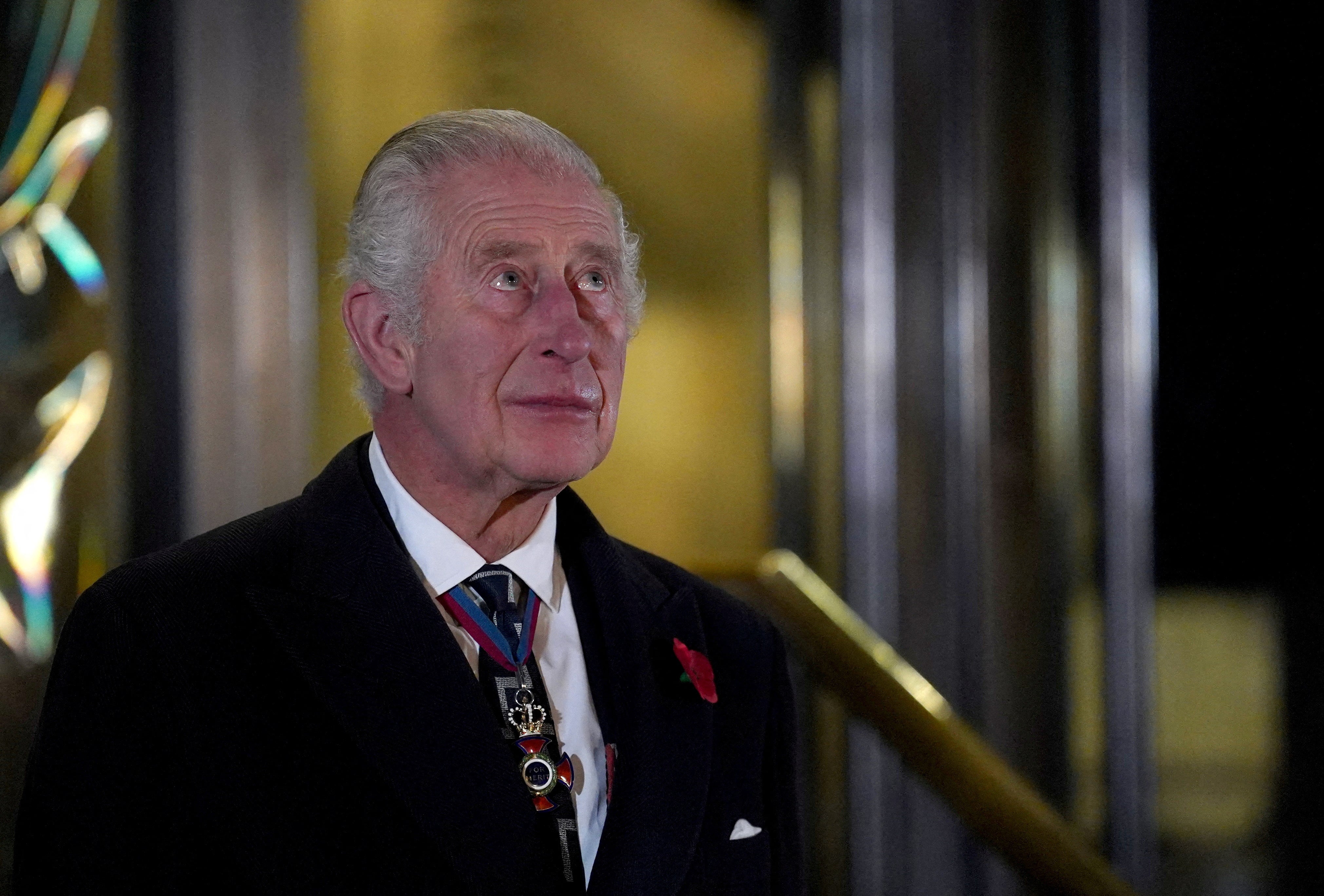 An emotional King Charles reacts after unveiling statues of his mother and father