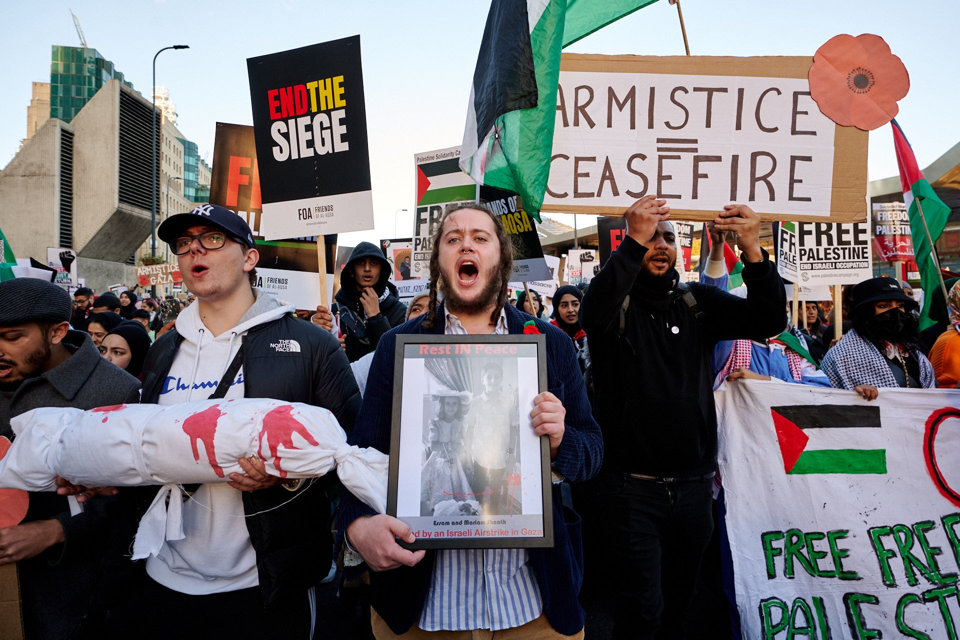 A group of protesters call for a ceasefire as they march towards the American Embassy