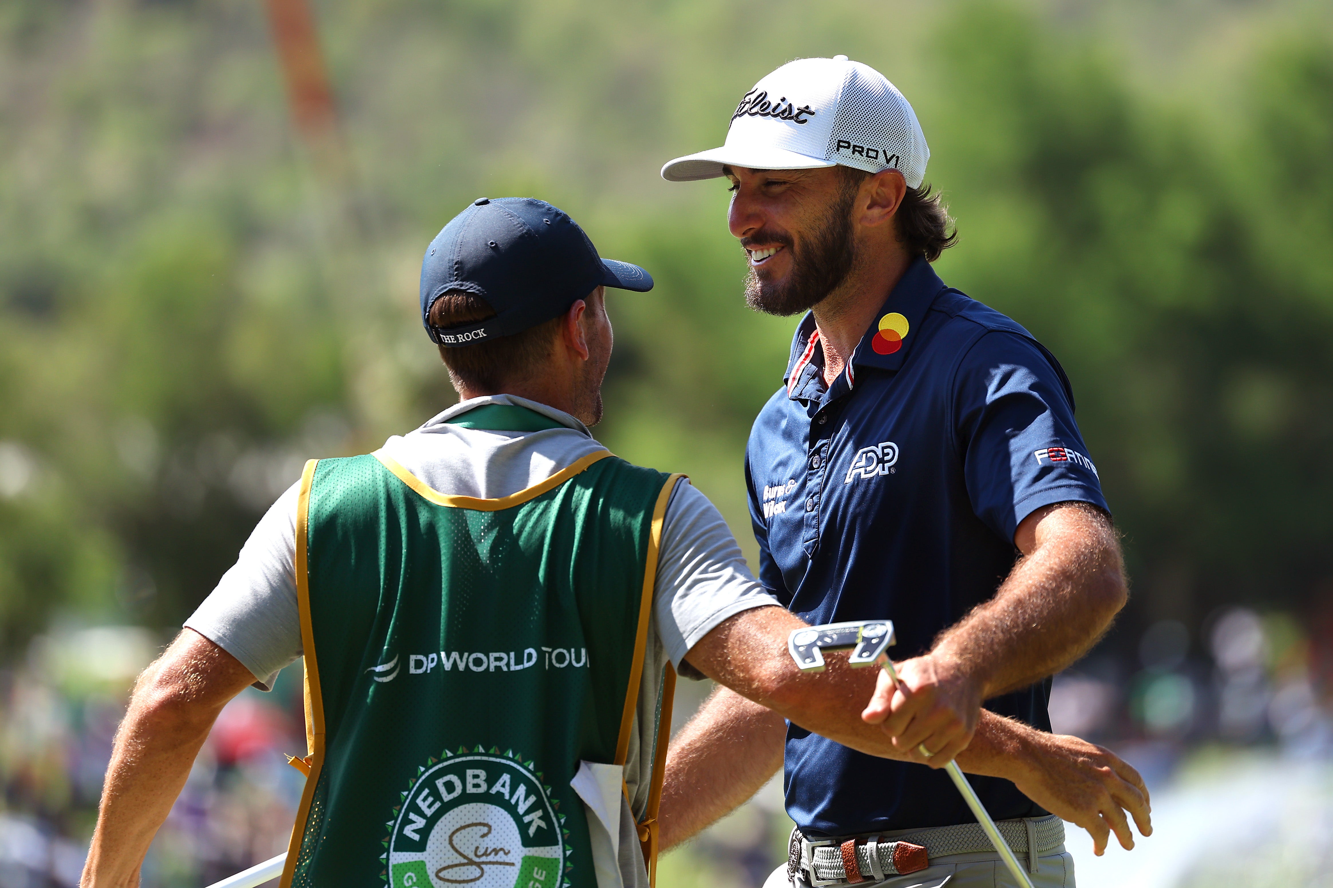 Max Homa of the United States celebrates victory with his caddie