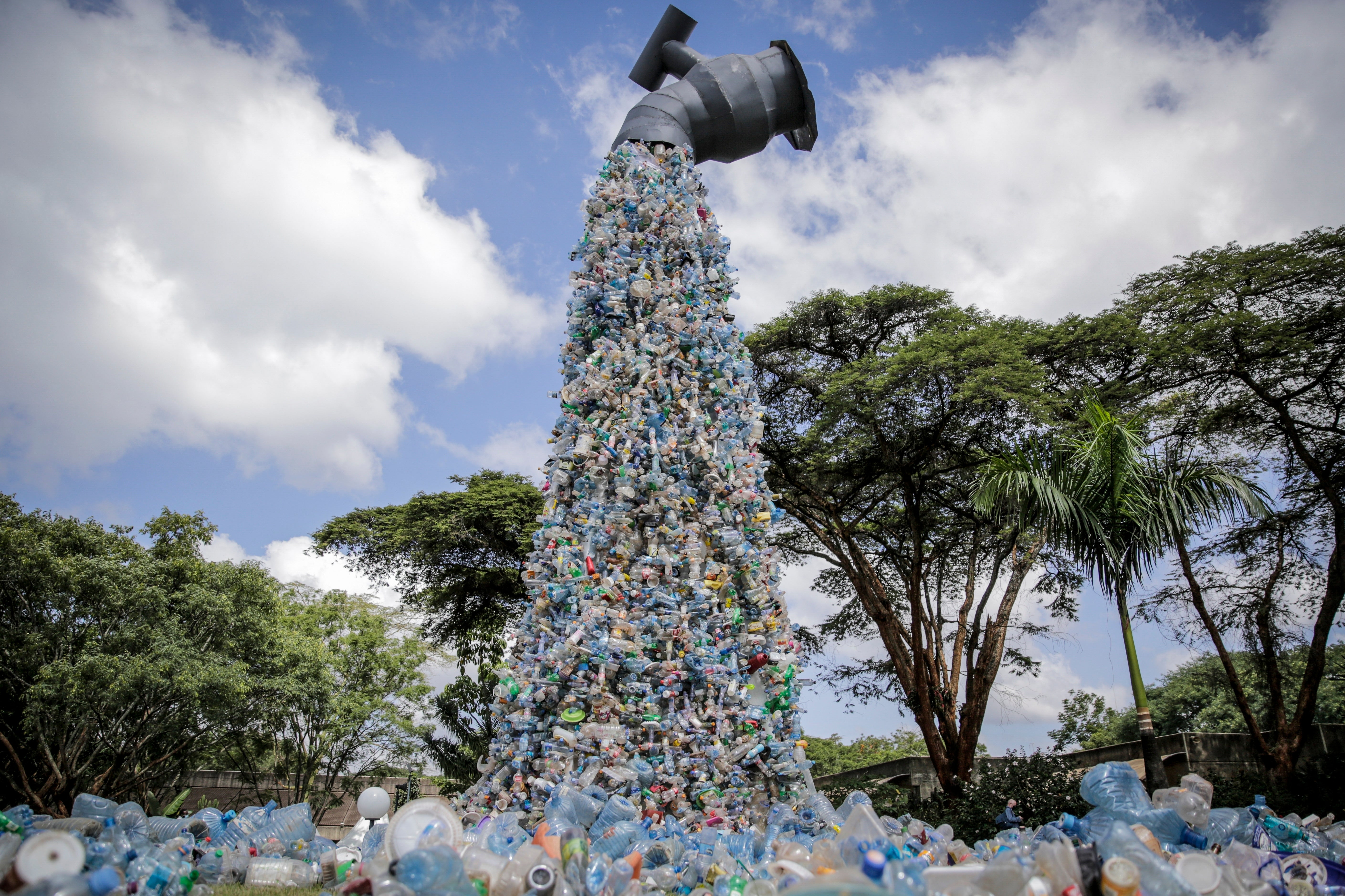 FILE - A giant art sculpture showing a tap outpouring plastic bottles, each of which was picked up in the neighbourhood of Kibera, during the UN Environment Assembly (UNEA) in Nairobi, Kenya, 2 March 2022