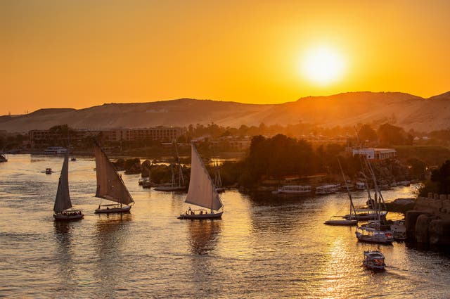 <p>A view on felucca boats on Nile river in Aswan at sunset</p>