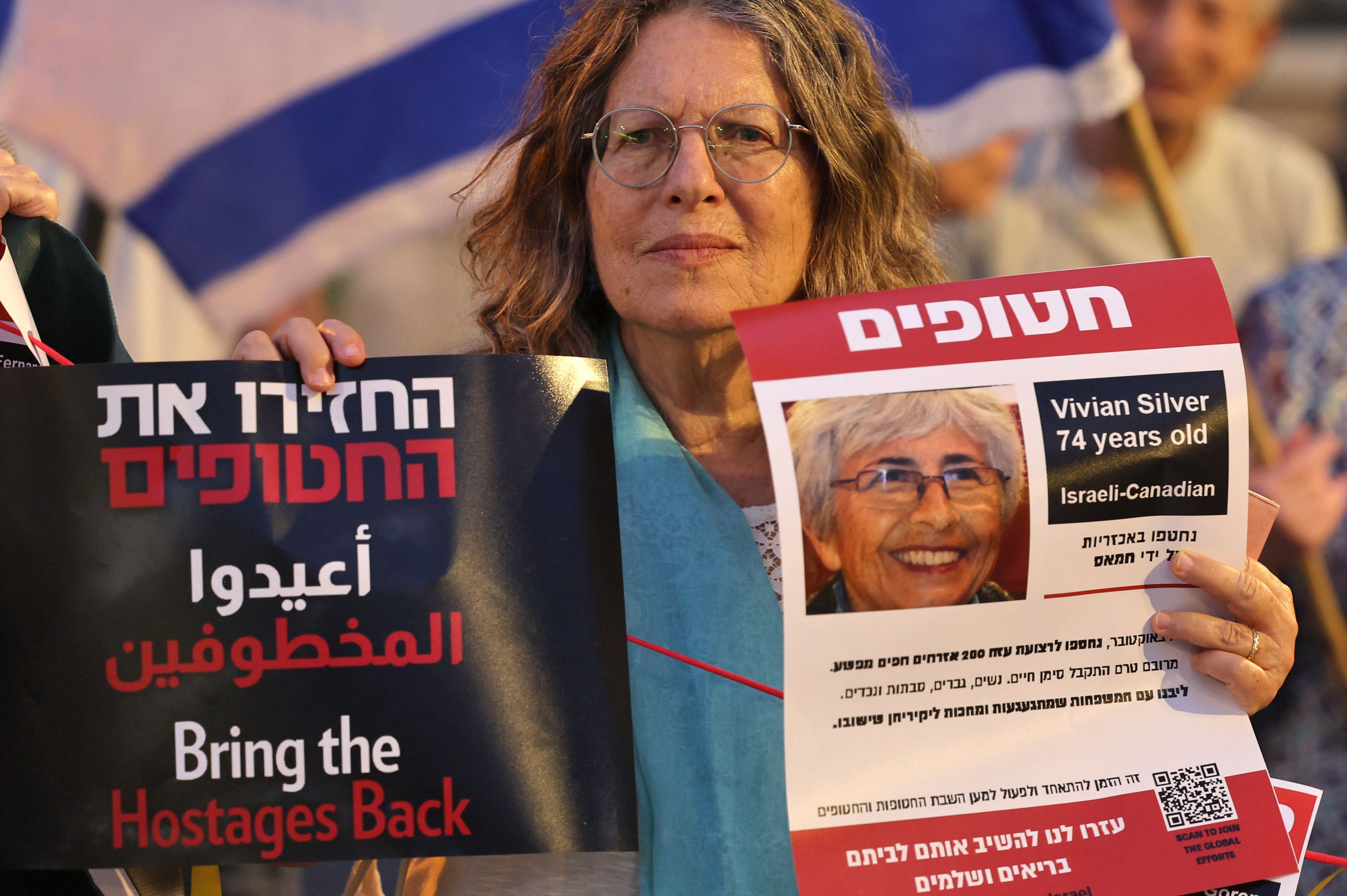 A demonstrator holds a poster bearing the image of Israeli-Canadian Vivian Silver
