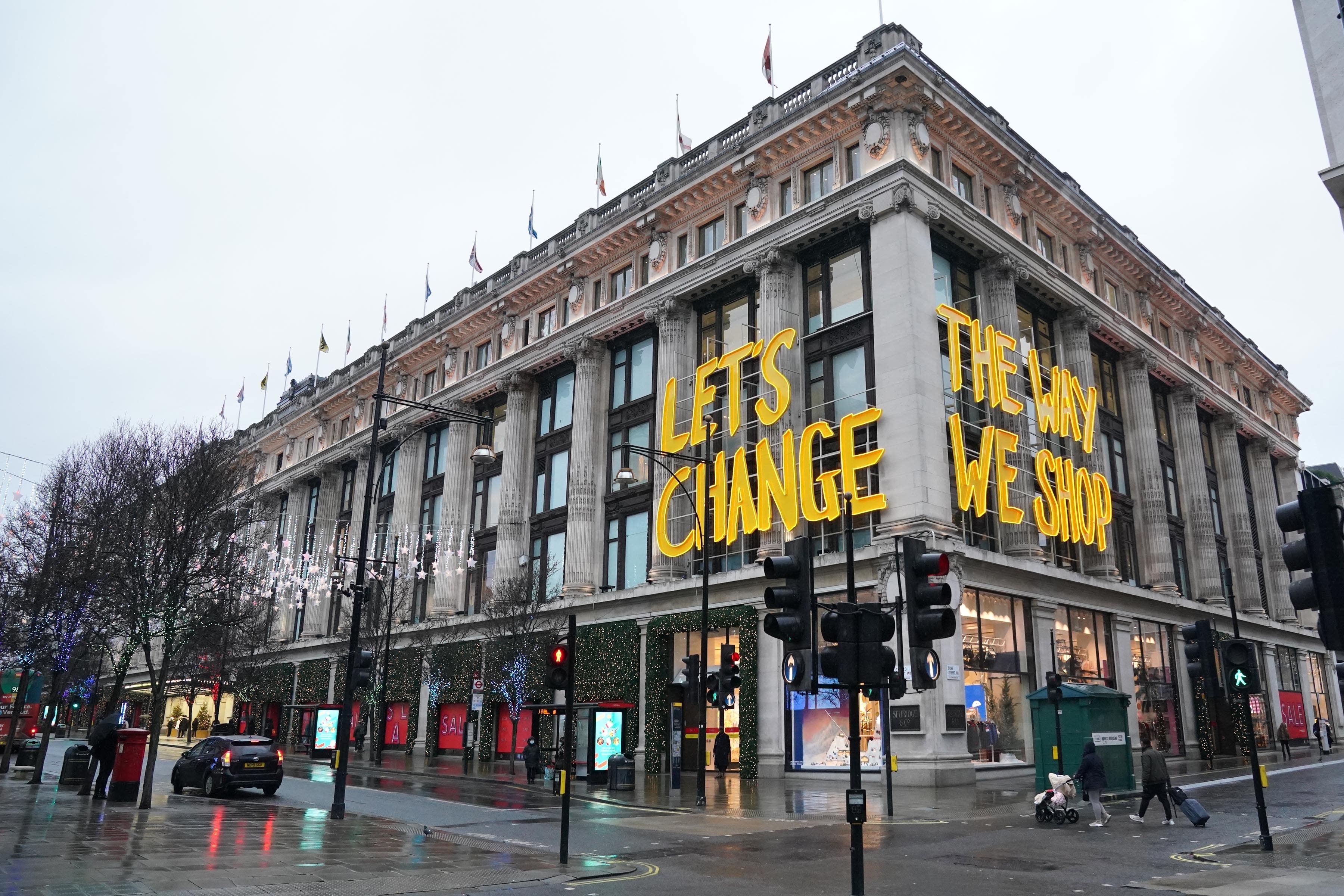 People walk past Selfridges department store on Oxford Street in London (Jonathan Brady/PA)