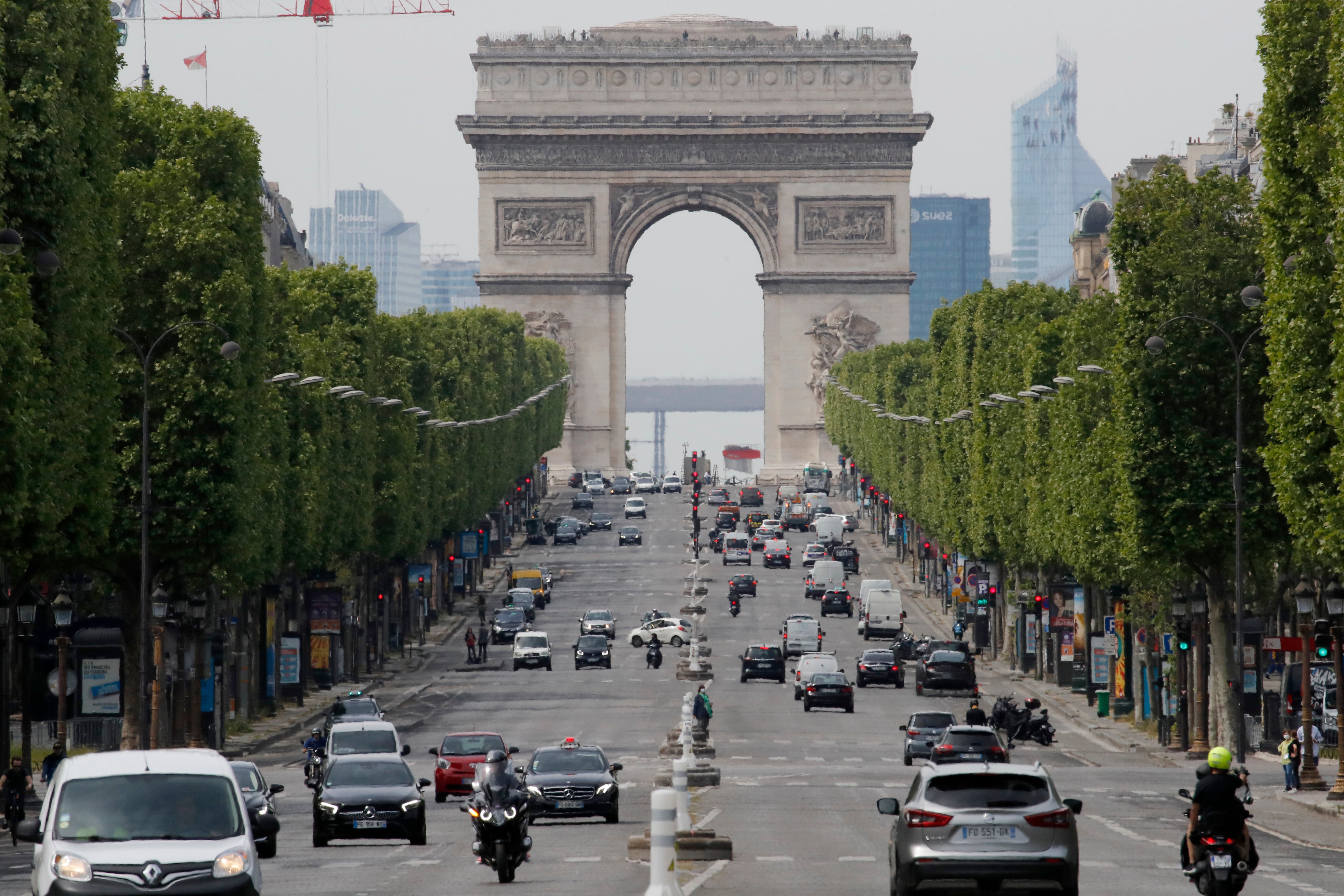 Cars drive on the Champs Elysee avenue, Thursday, May 7, 2020 in Paris