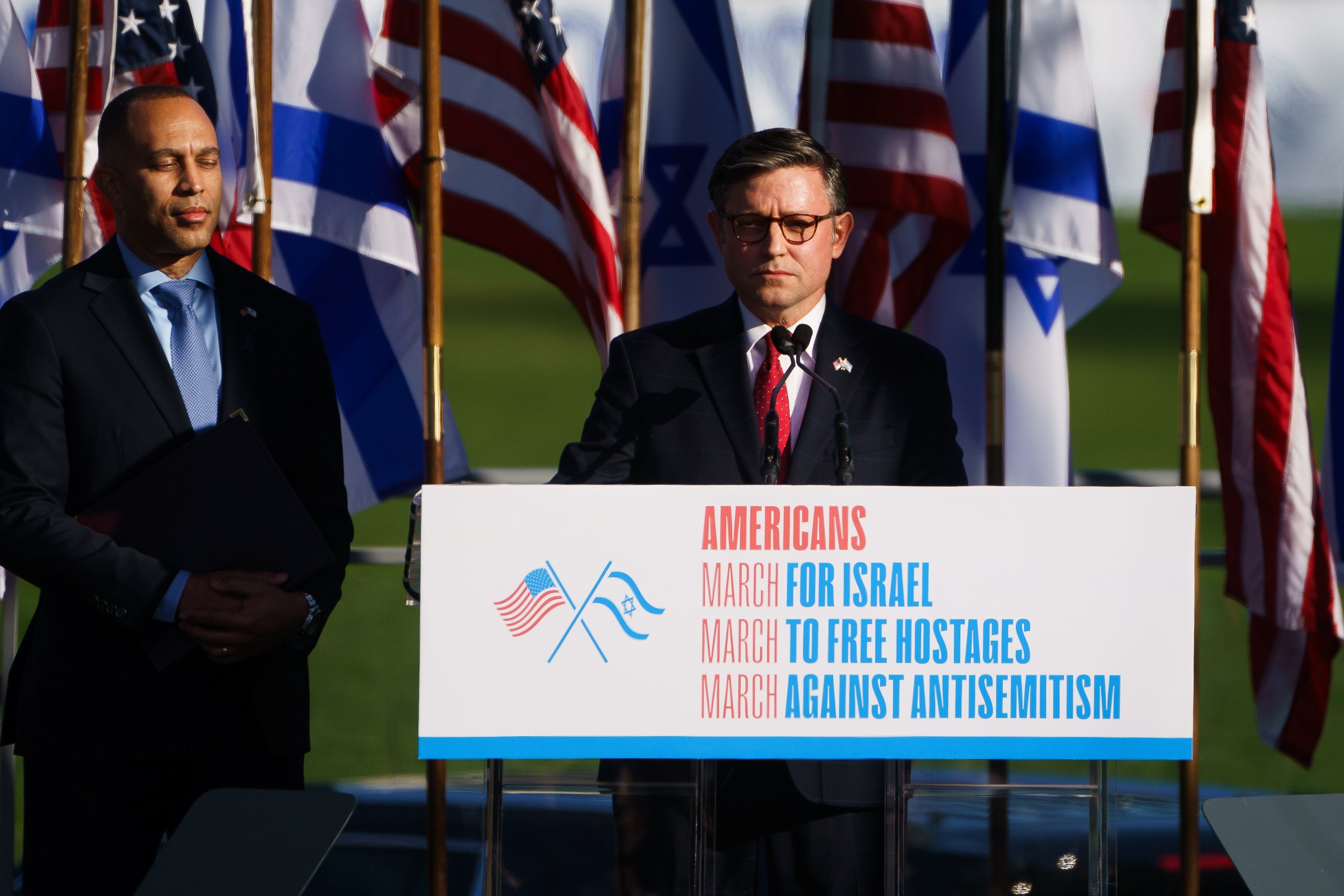 Democratic House Minority Leader Hakeem Jeffries, left, watches Republican House Speaker Mike Johnson address a March for Israel rally where he said calls for a ceasefire in Gaza are ‘outrageous’