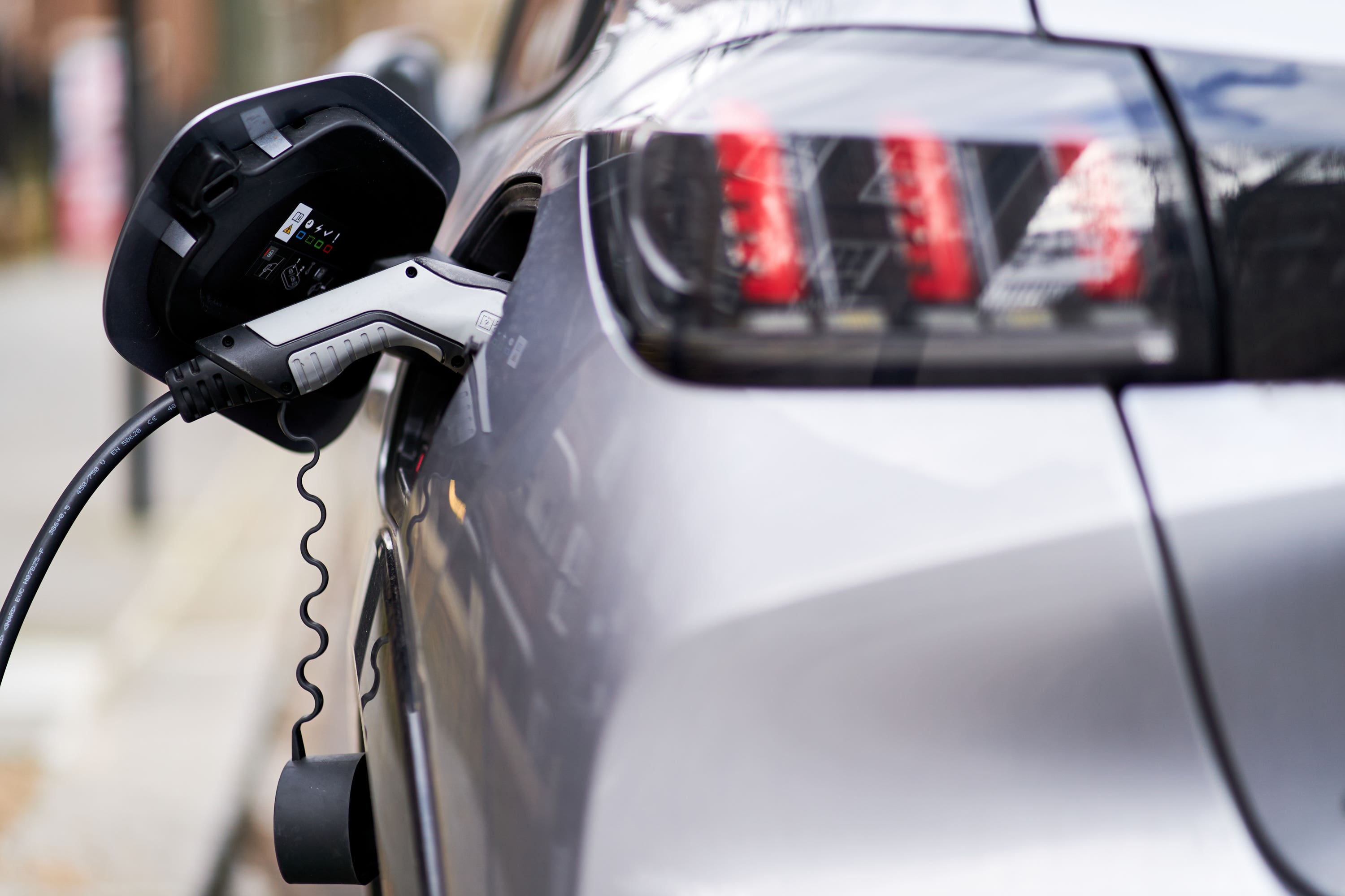 An electric car plugged into a Electric vehicle charging point (John Walton/PA)