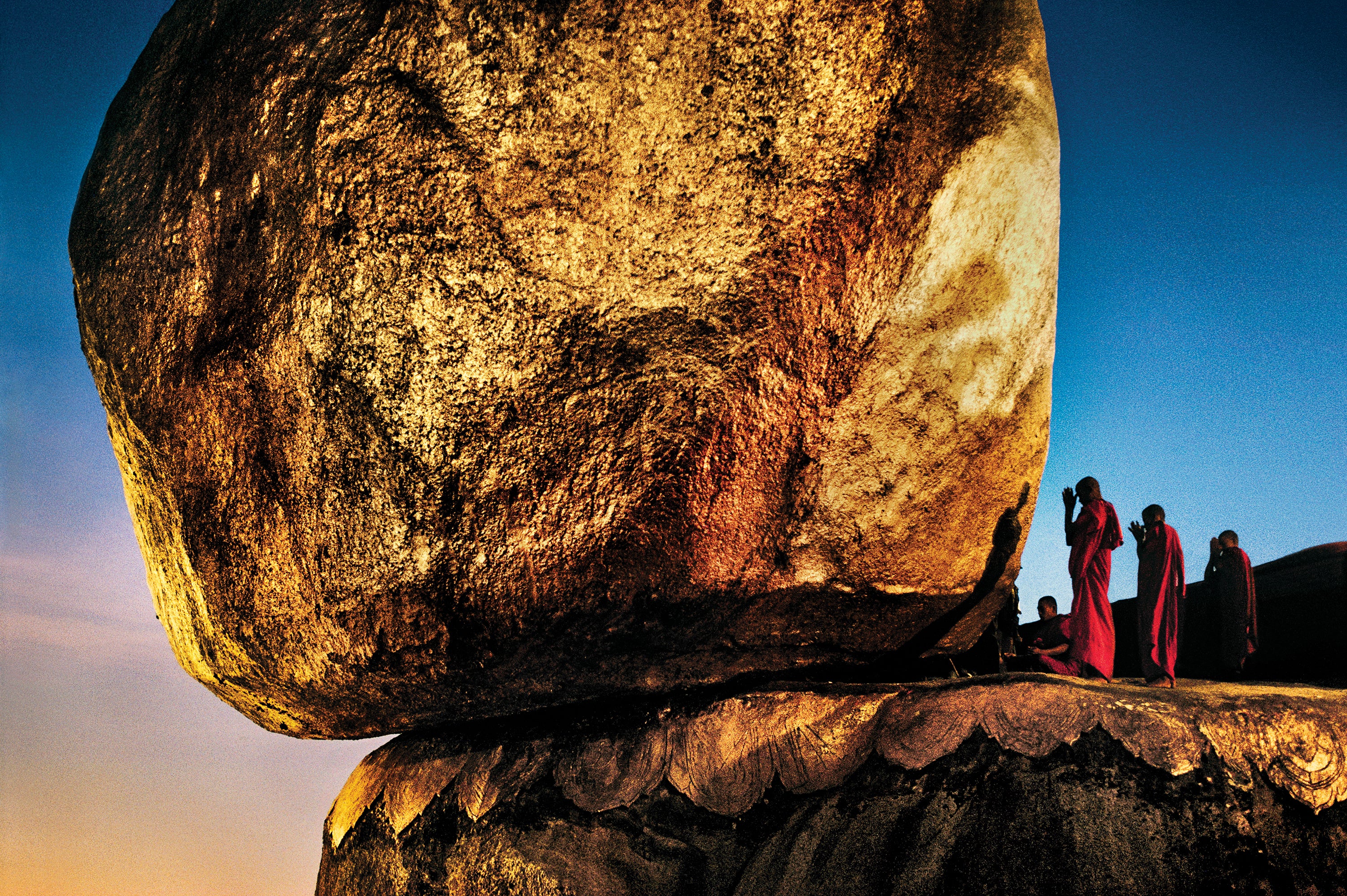 Monks pray at Golden Rock, an important Buddhist site in Myanmar. McCurry spent days there determining the best vantage point and time. The picture was taken about 10 minutes after sunset