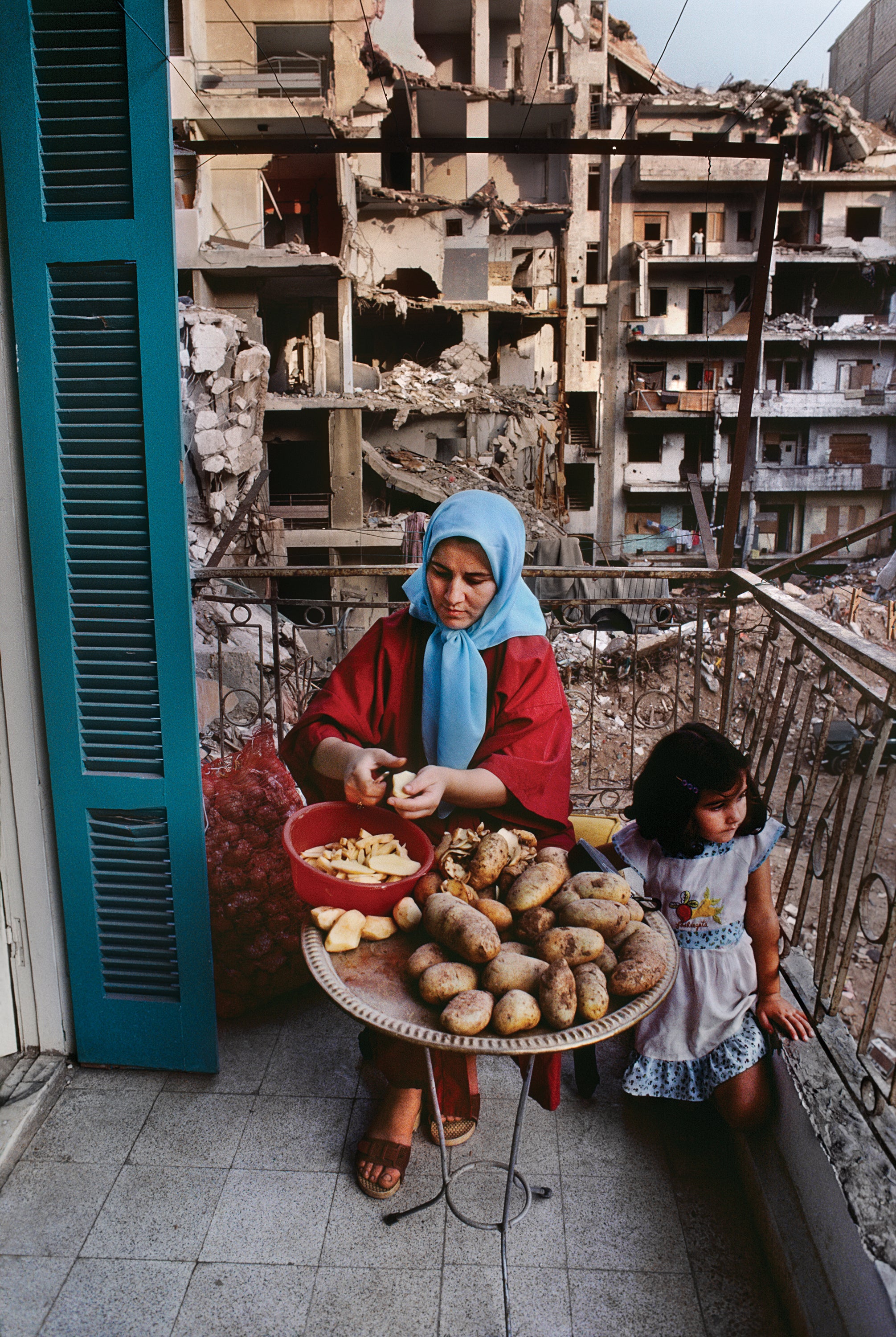 A mother peels potatoes in Beirut, Lebanon