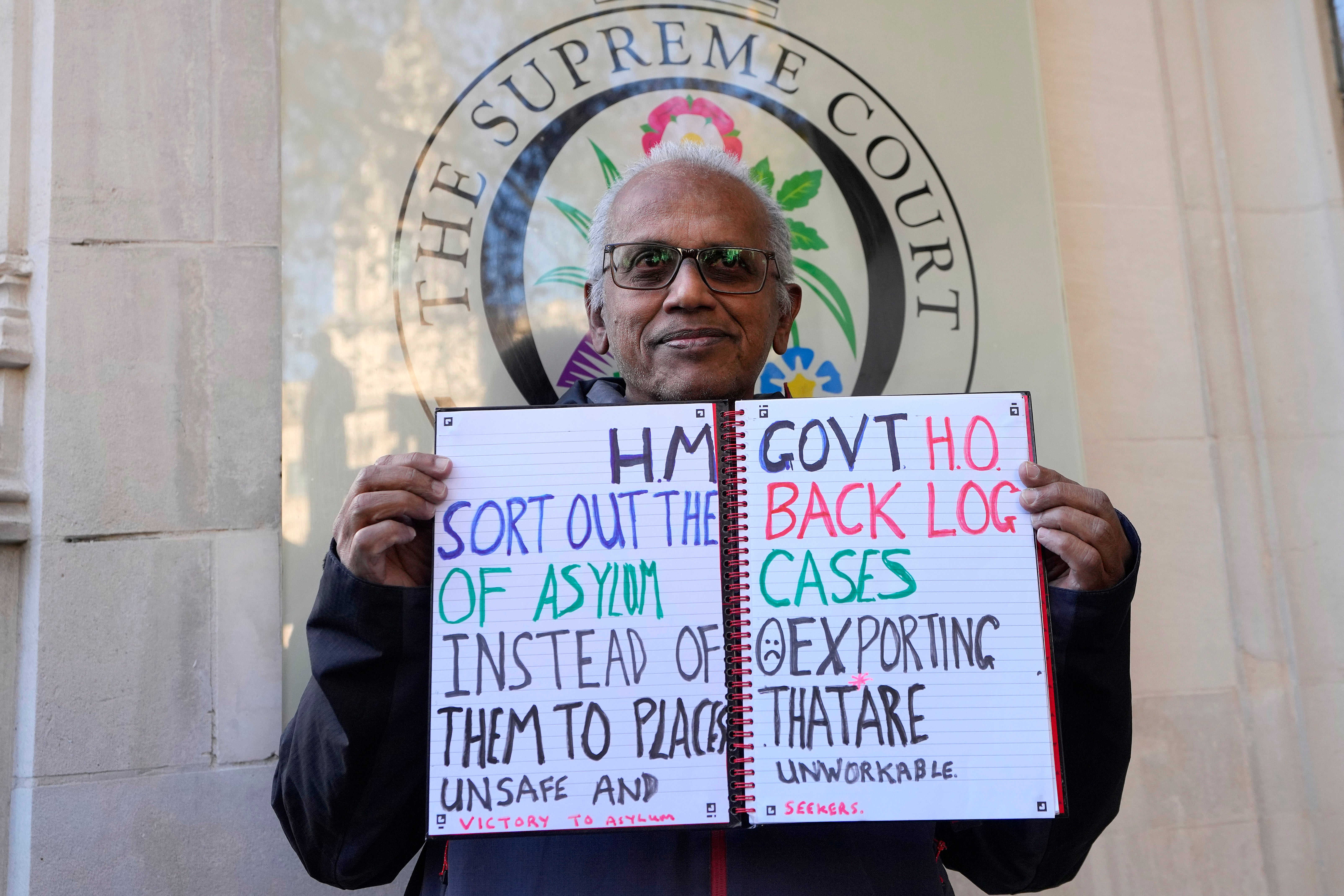 A protester stands outside the Supreme Court in London