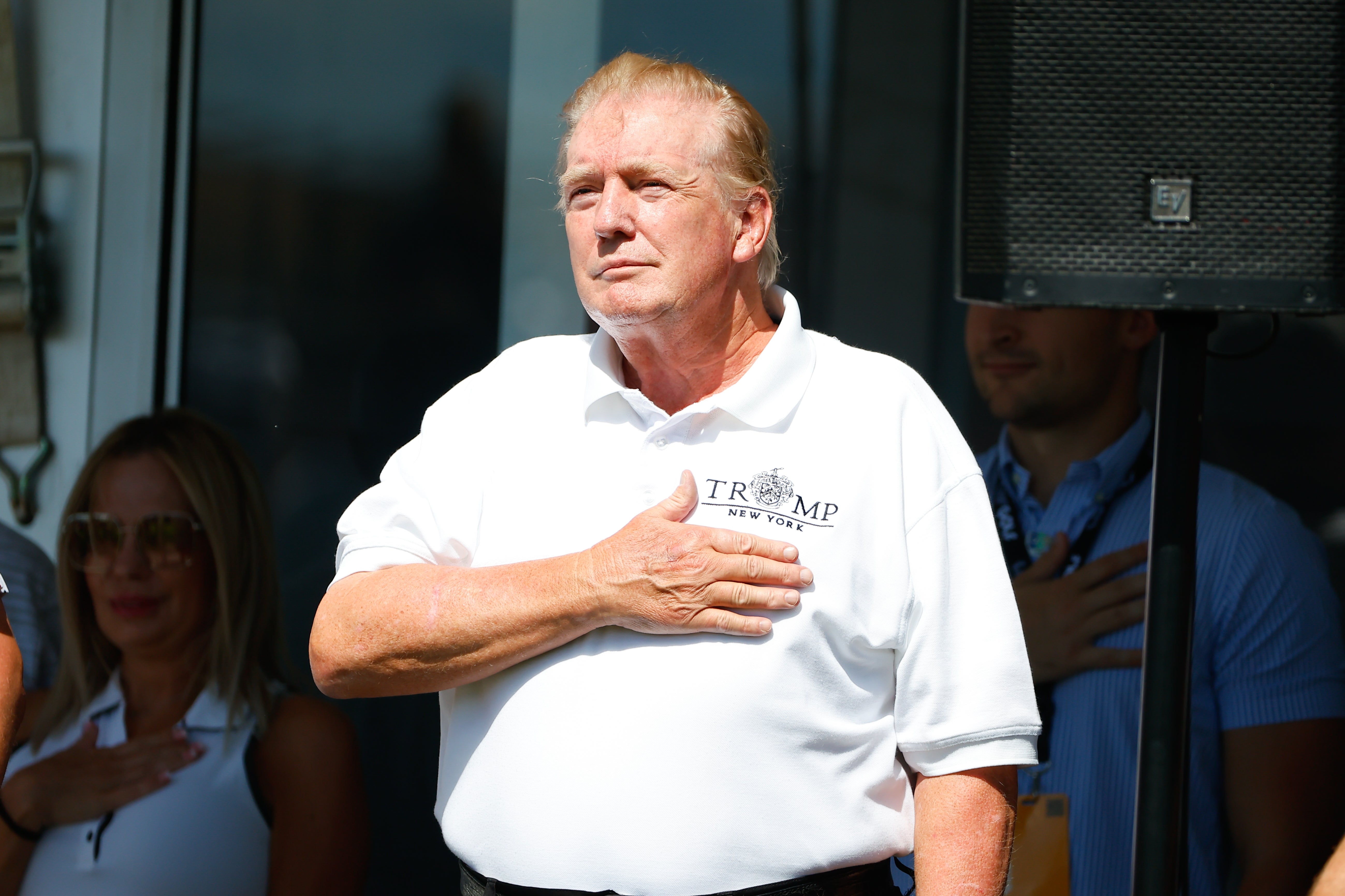 Trump puts his hand on his heart during a performance of the National Anthem at his golf course at Bedminster, New Jersey in July 2022. If re-elected he would become the oldest president in US history