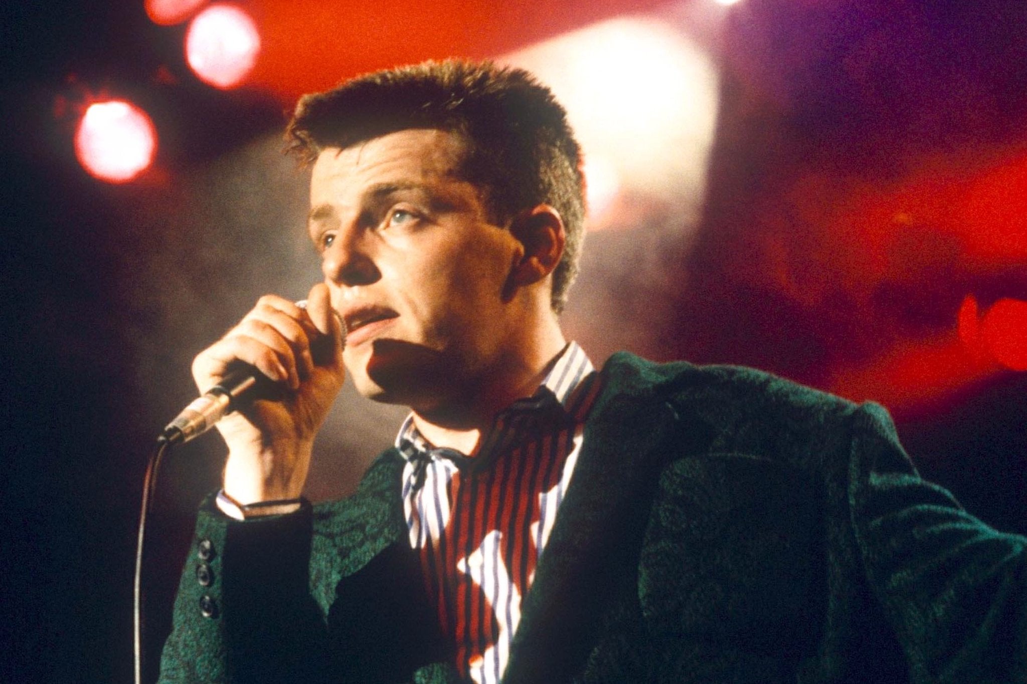 Suggs, then 24, performing at a Madness concert in 1985