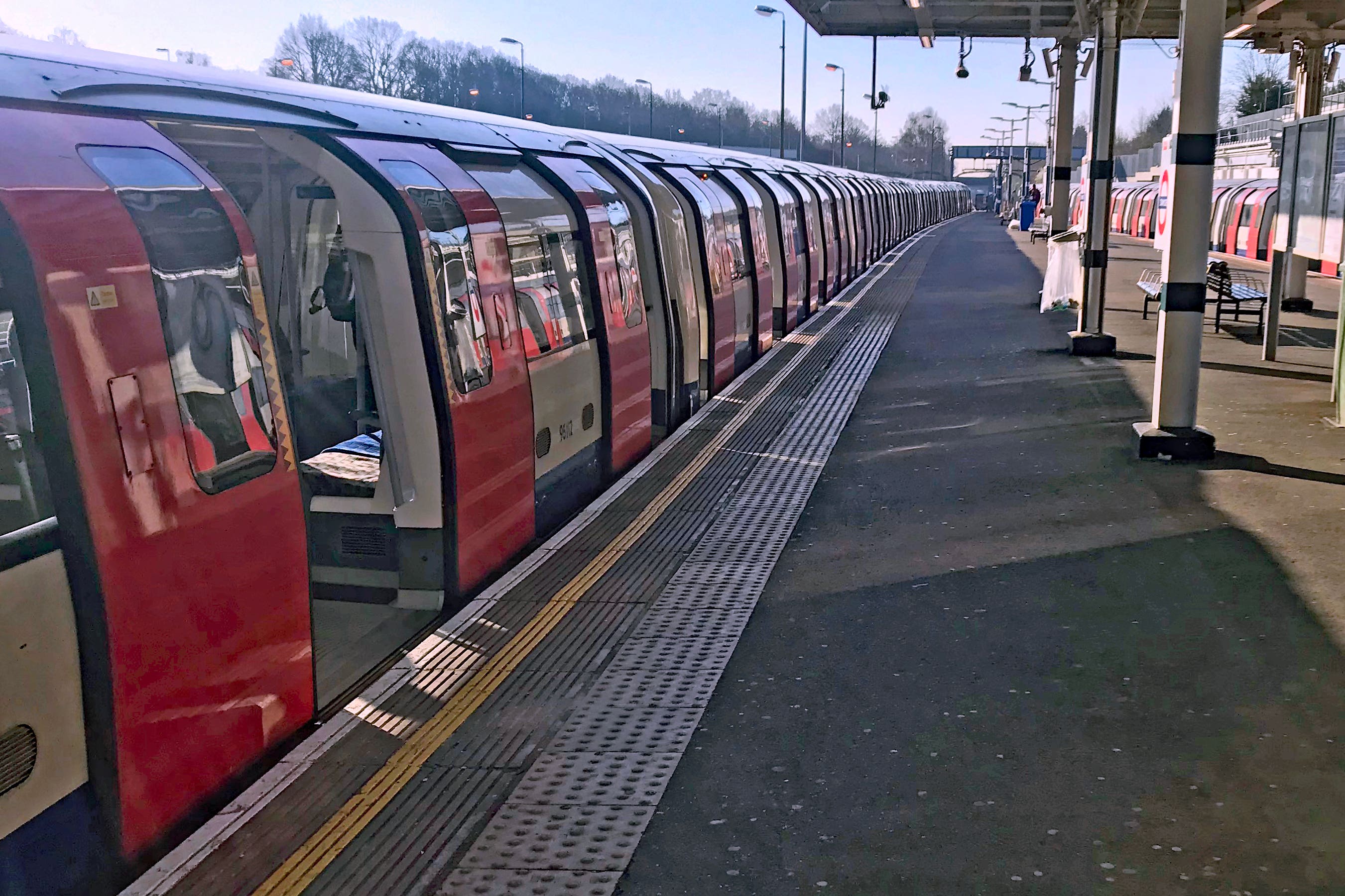 An empty platform alongside an Underground train at rush hour (PA)