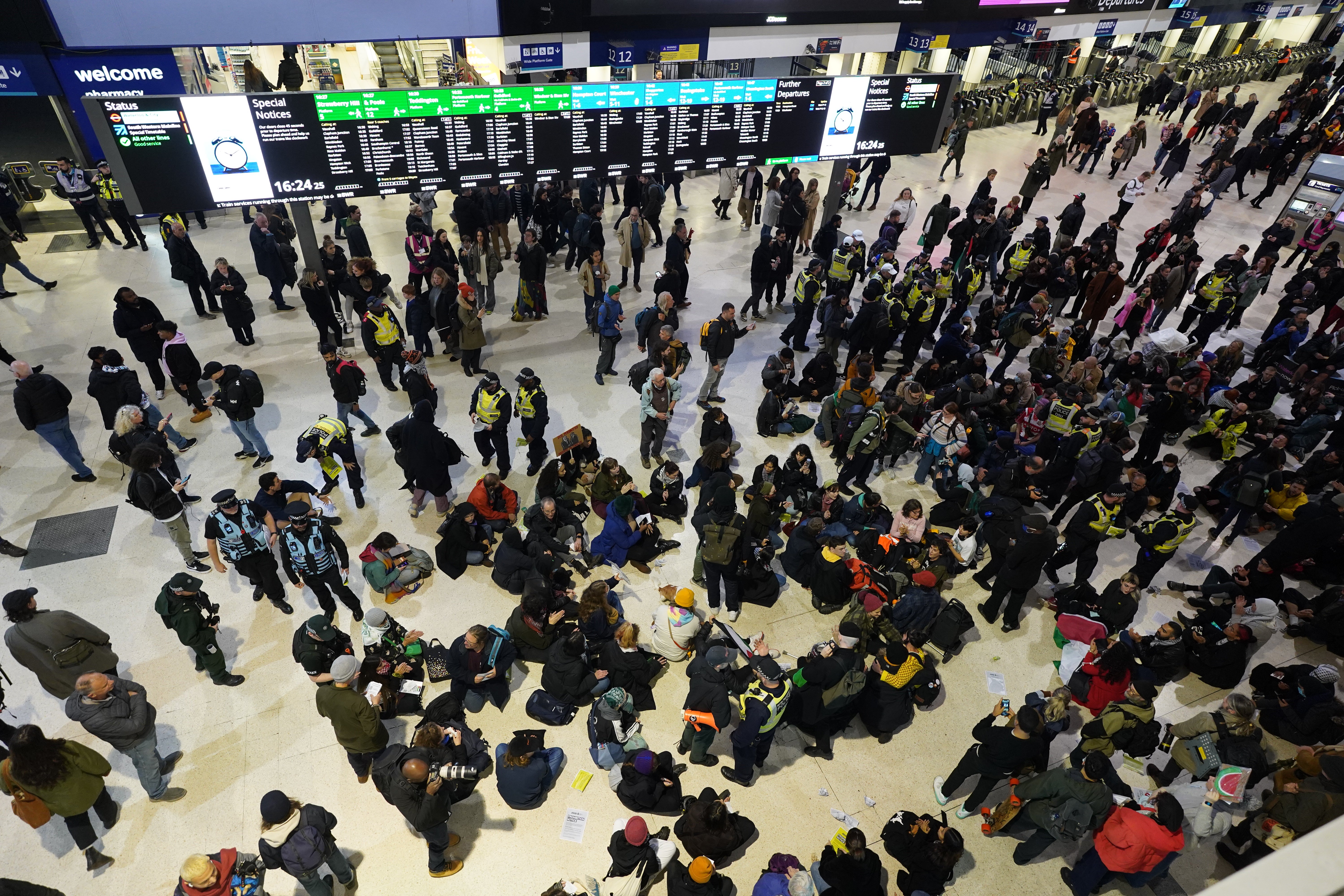 Police officers remove pro-Palestinian protesters that took part in a sit-in demonstration at London's Waterloo Station