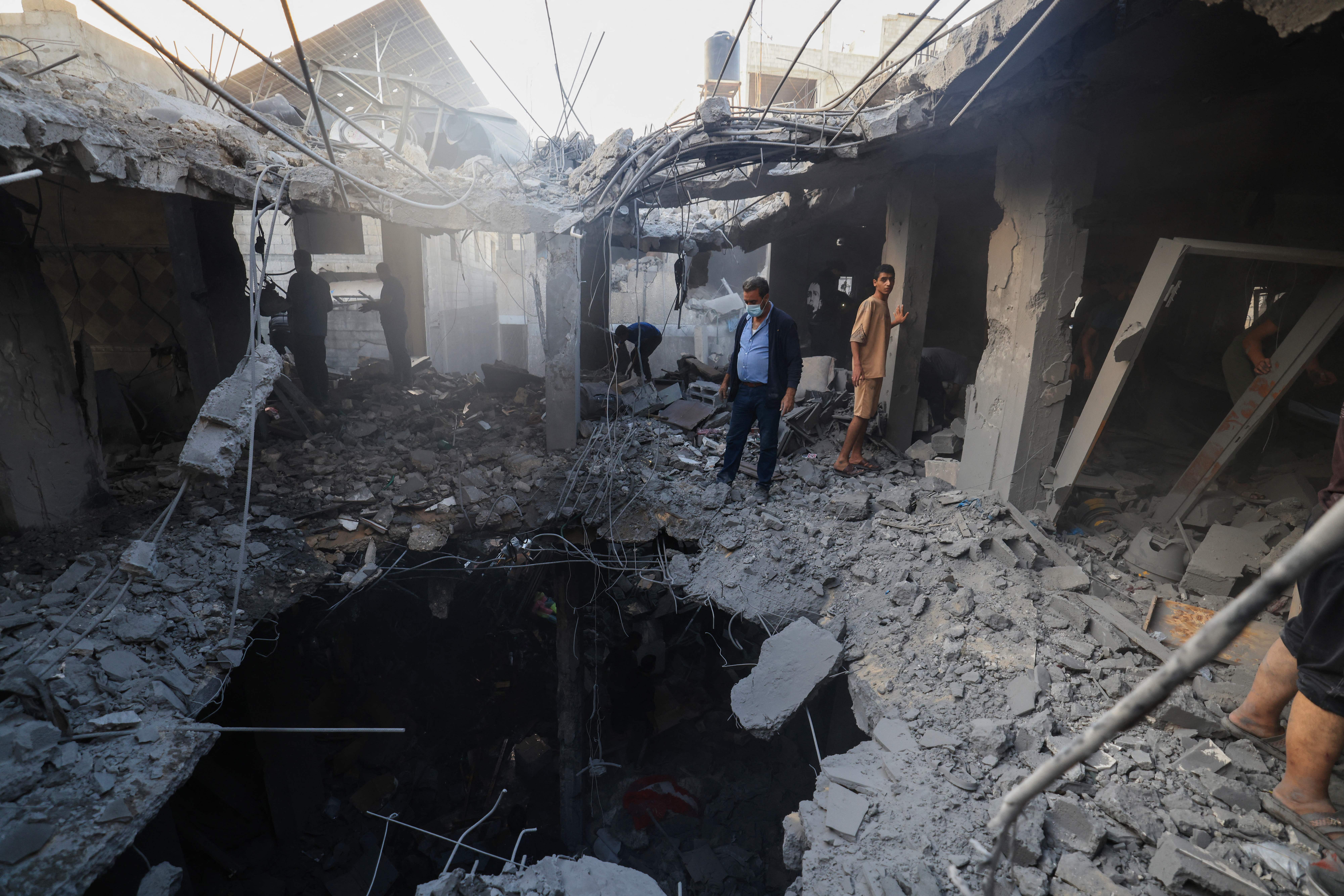 Palestinians search the rubble of a building for survivors follwoing Israeli bombardment in Khan Yunis in the southern Gaza Strip on 18 November 2023 amid ongoing battles between Israel and the Palestinian militant group Hamas.