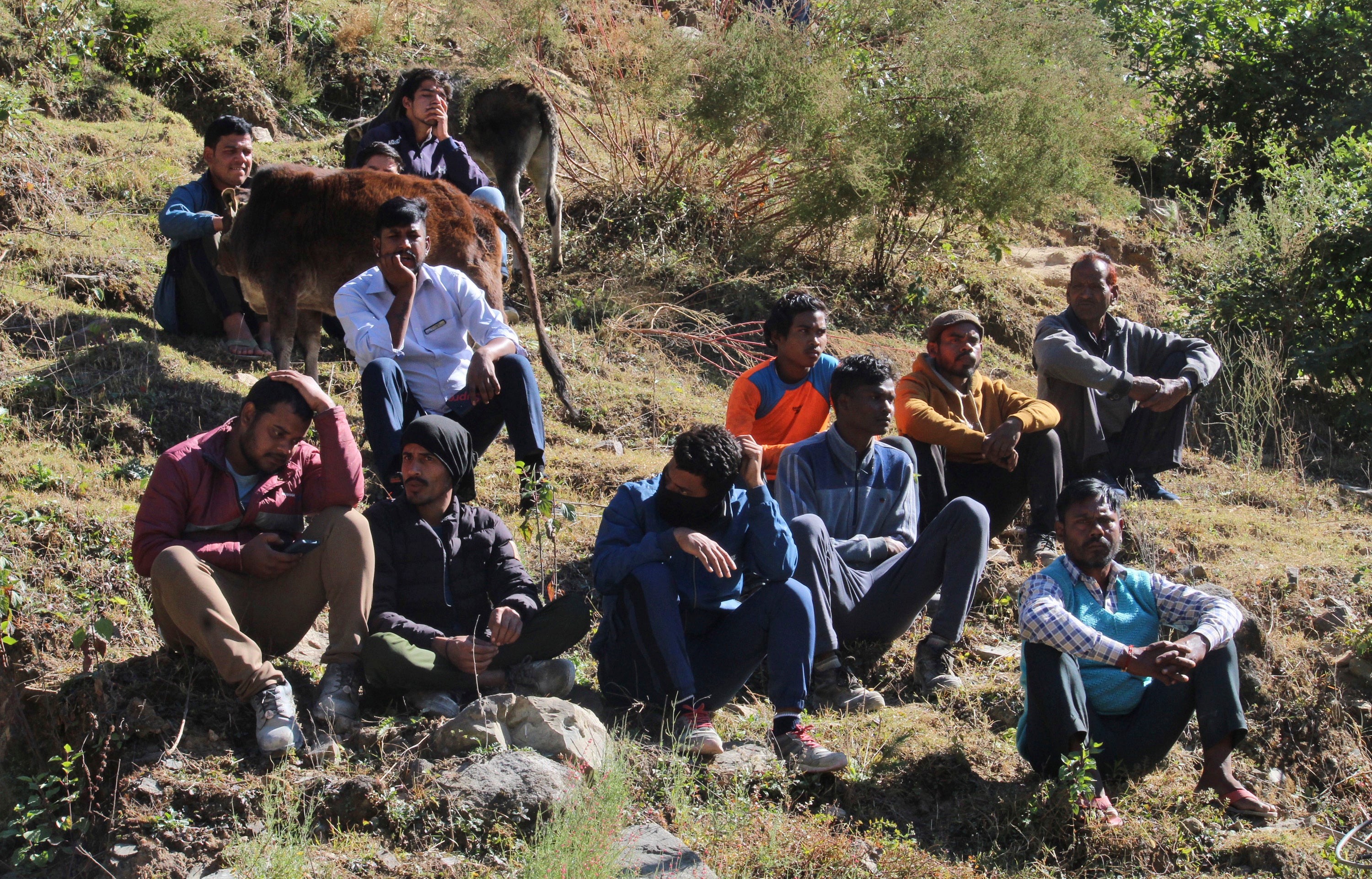 People watch rescue work at the site of an under-construction road tunnel that collapsed in mountainous Uttarakhand state, India, Saturday, 18 Nov 2023.