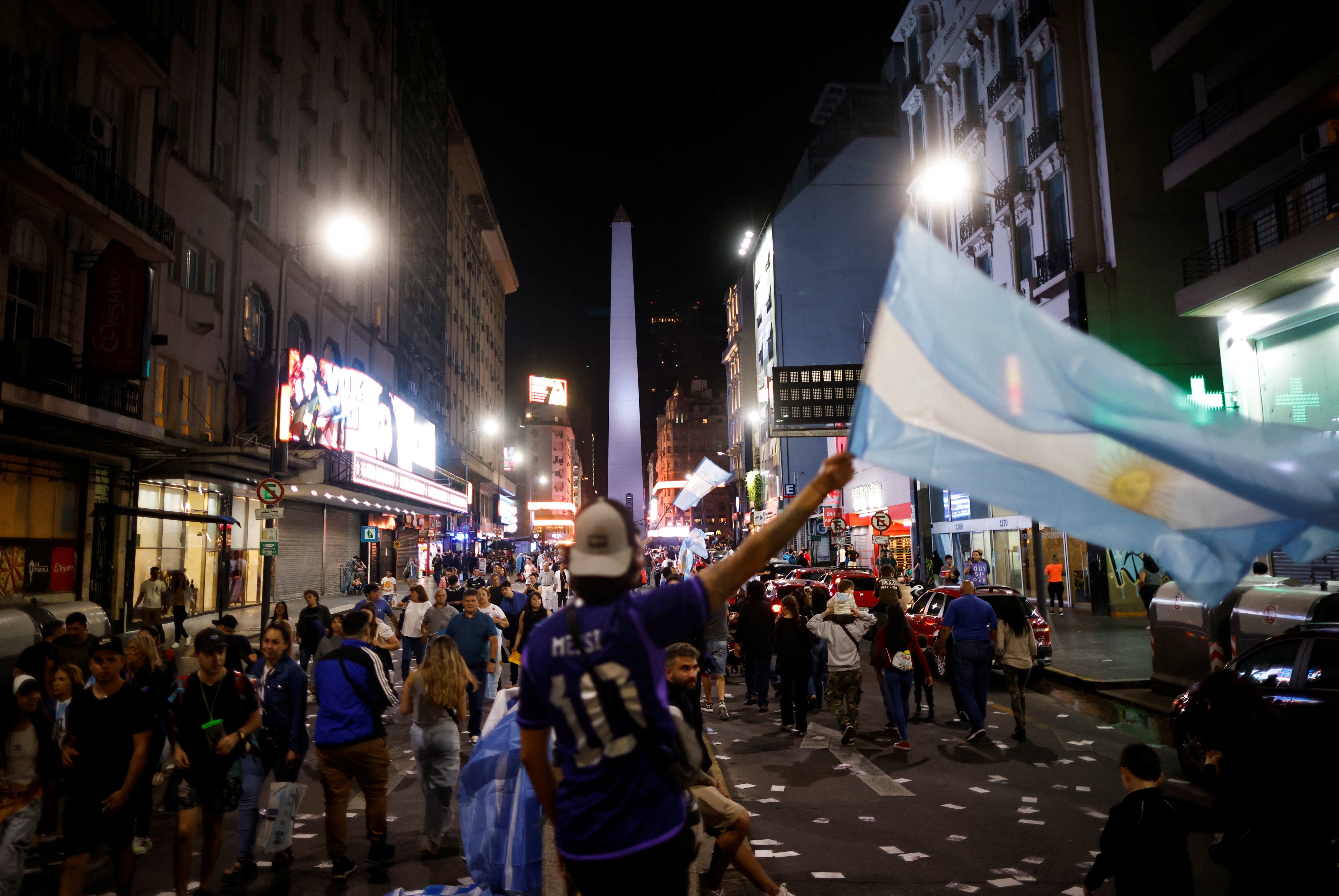 Argentine president-elect Javier Milei’s supporters celebrate after Milei wins the runoff presidential election