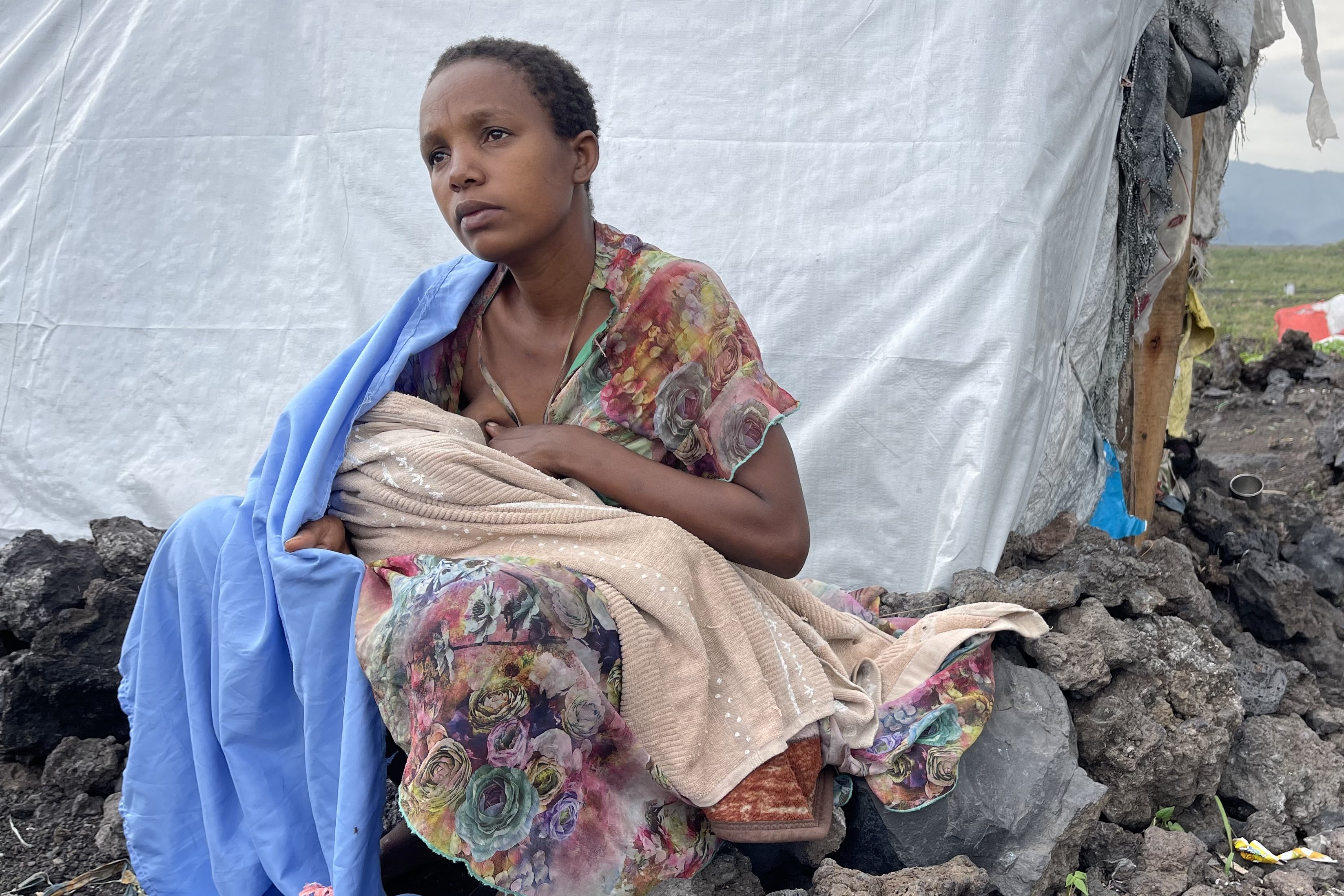 Sifa* breastfeeding her young baby in the Mugunga camp in the Democratic Republic of Congo