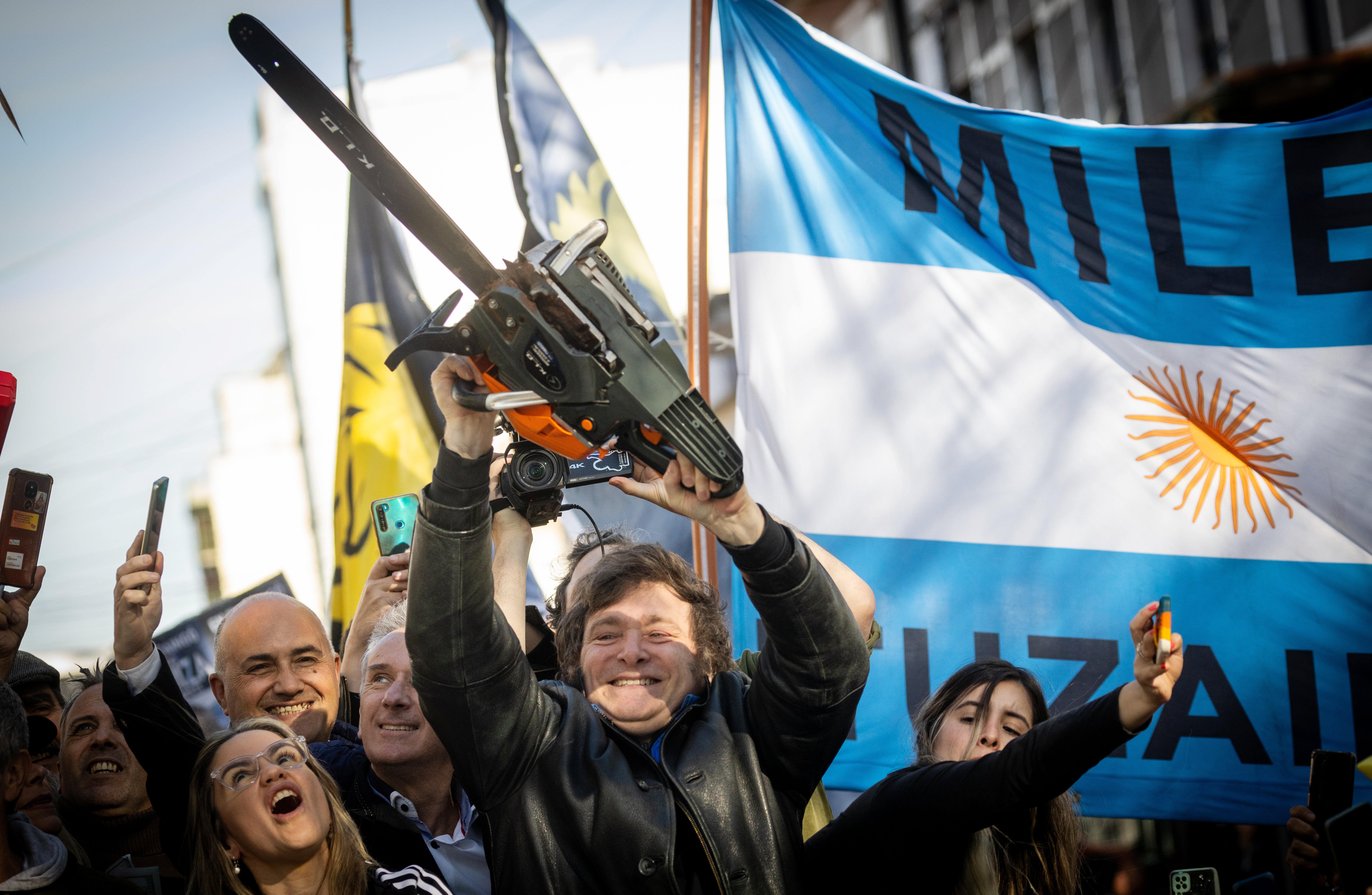 Presidential candidate Javier Milei of La Libertad Avanza lifts a chainsaw