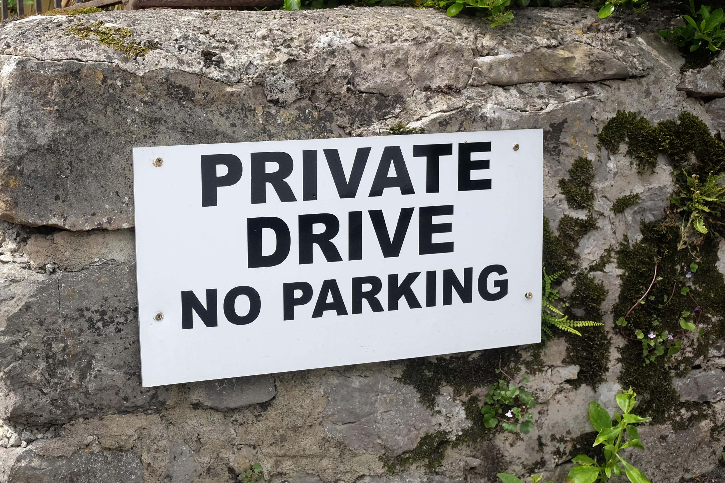 Nearly half of UK homeowners say neighbours have prevented them parking their vehicle, a survey suggests (Alamy/PA)