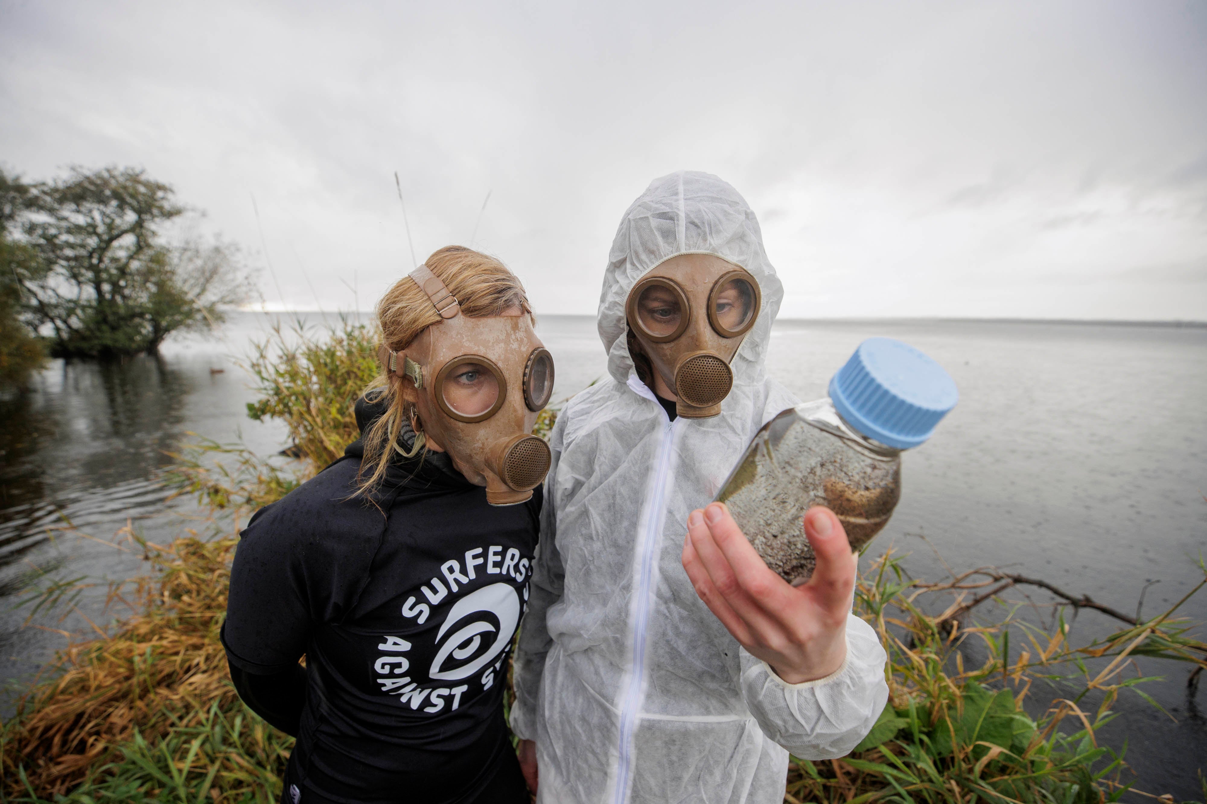 Carla Magee (left) and Aine McAuley from Surfers Against Sewage (SAS) protest against pollution at Lough Neagh in Northern Ireland, which has been polluted by deadly blue-green algae