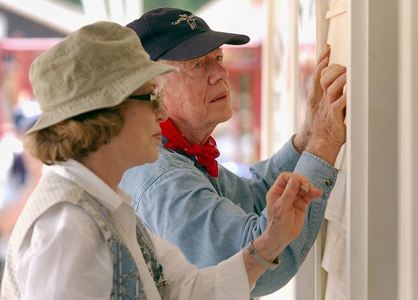 Carter and Rosalyn attach siding to the front of a Habitat for Humanity home being built in LaGrange, Georgia, 2003