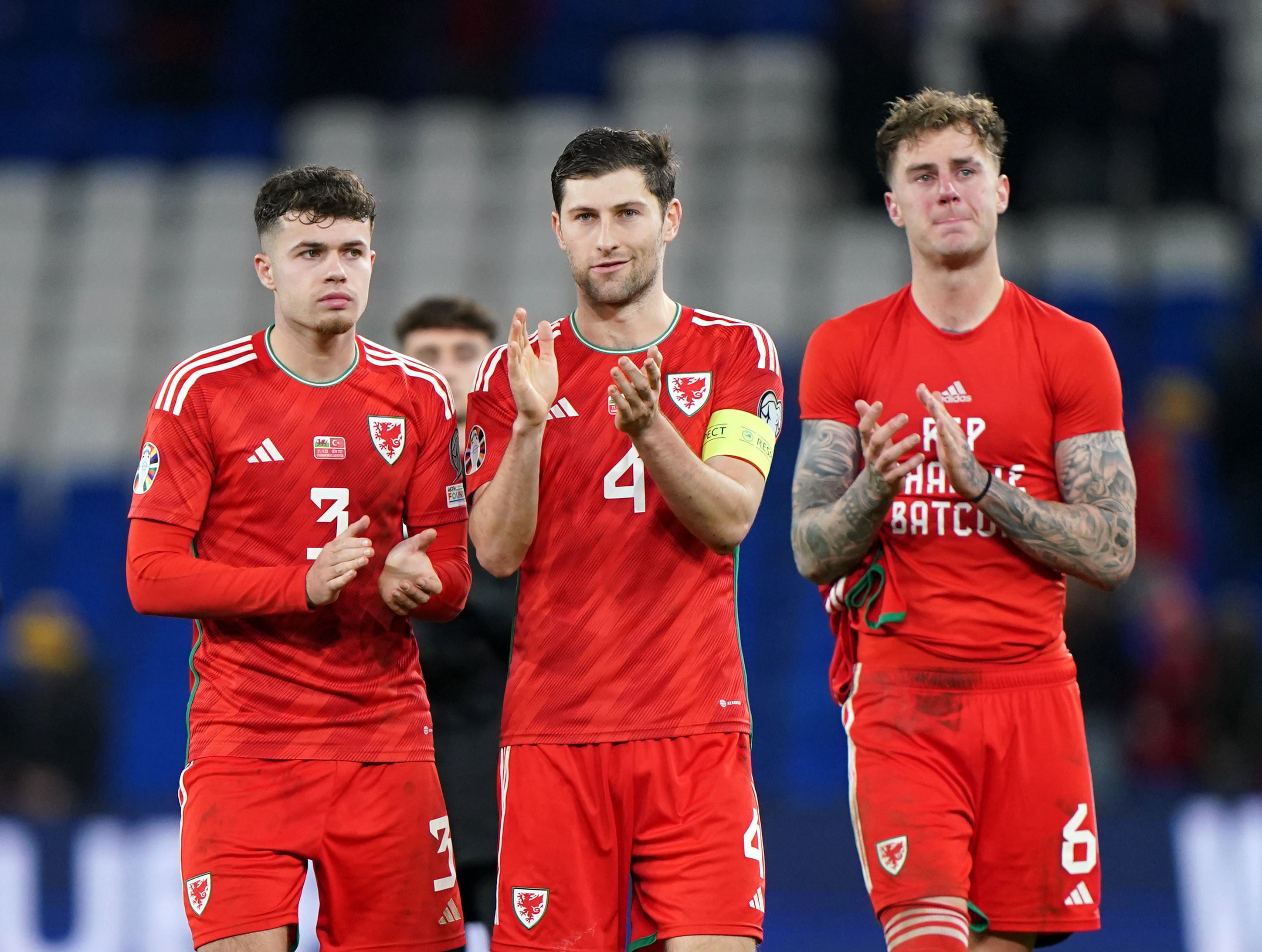 Wales captain Ben Davies applauds fans alongside his teammates