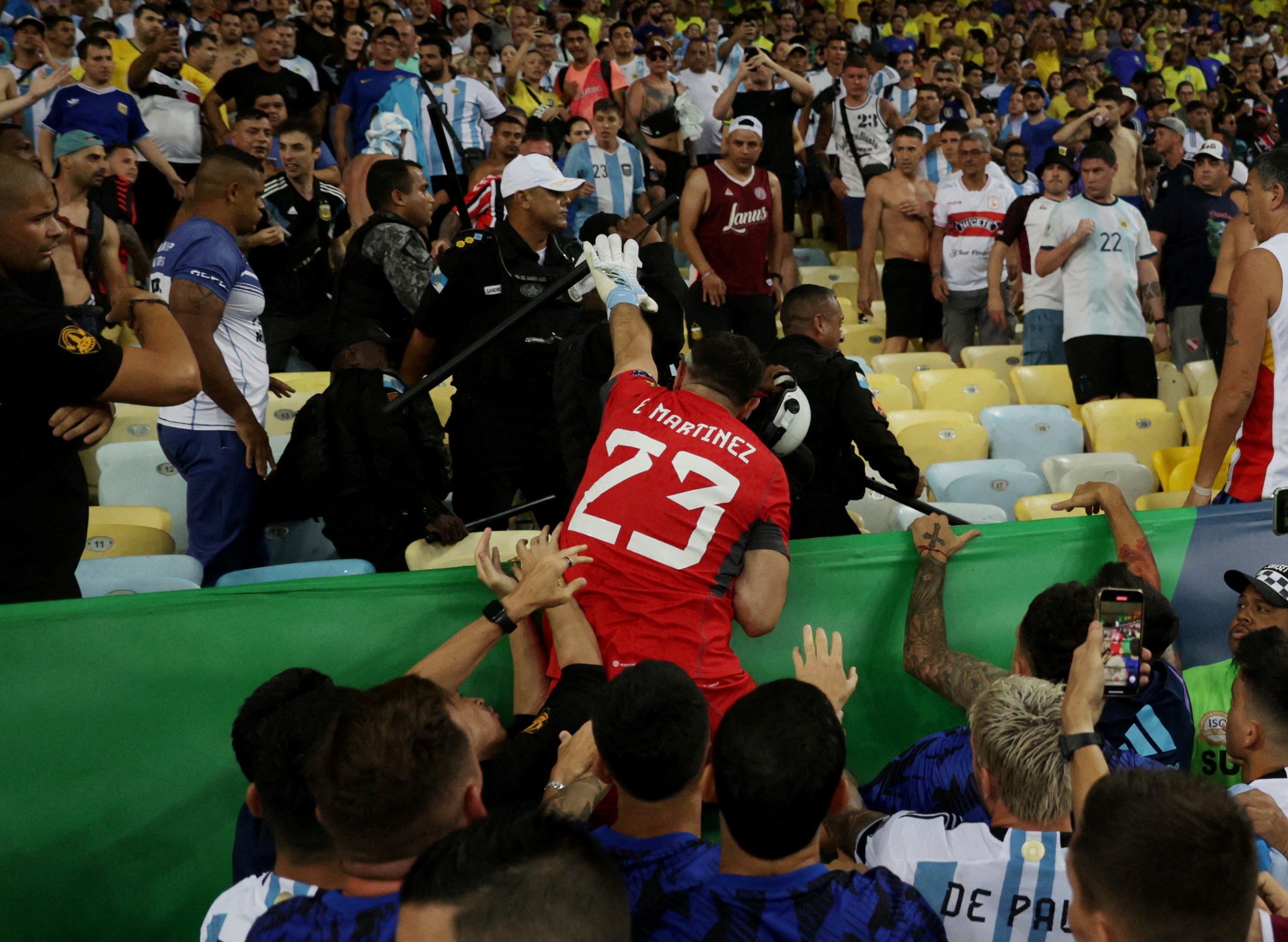 Goalkeeper Martinez attemps to grab a police officer’s baton