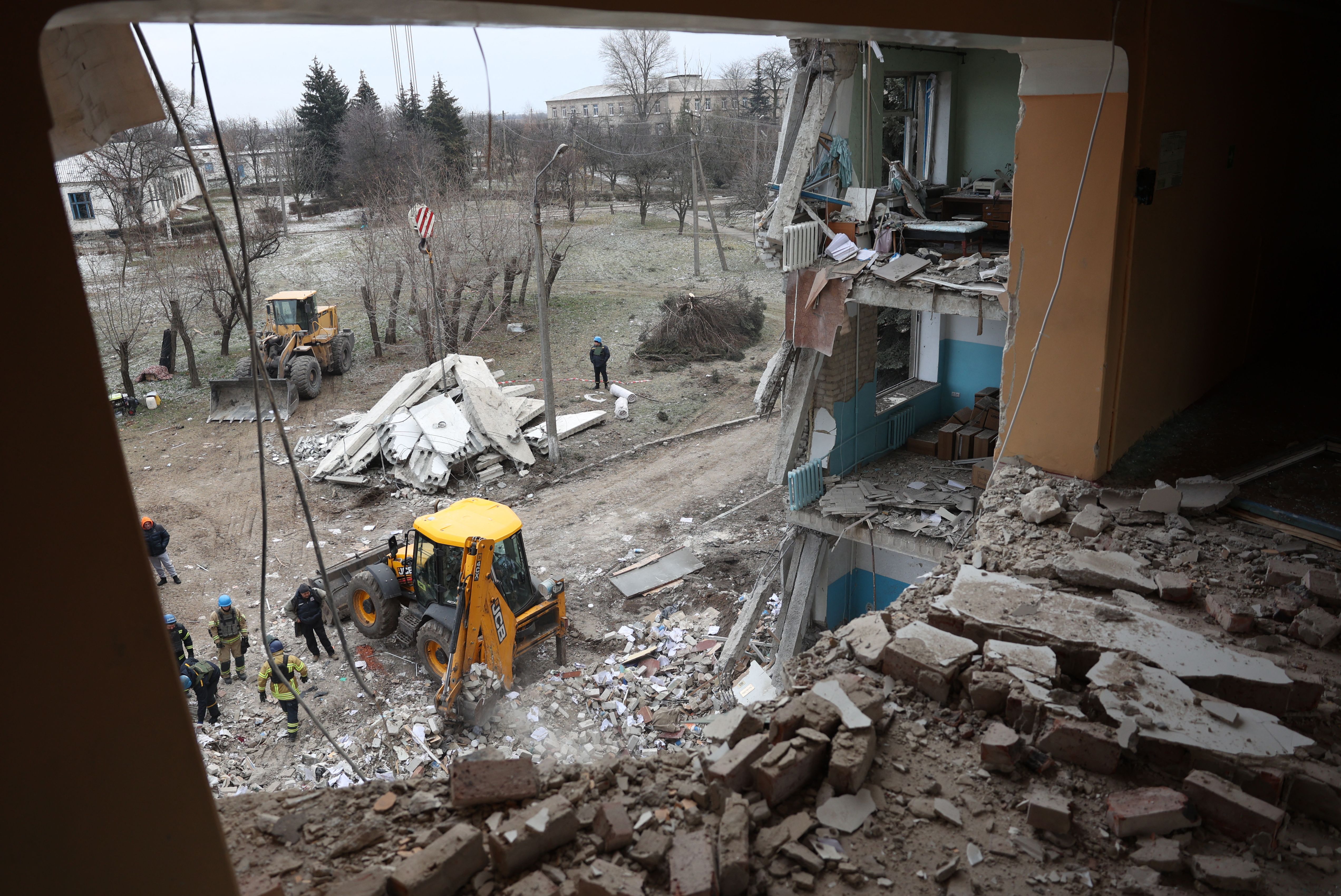 Rescuers clear debris in a hospital in Selydove damaged by a Russian missile strike