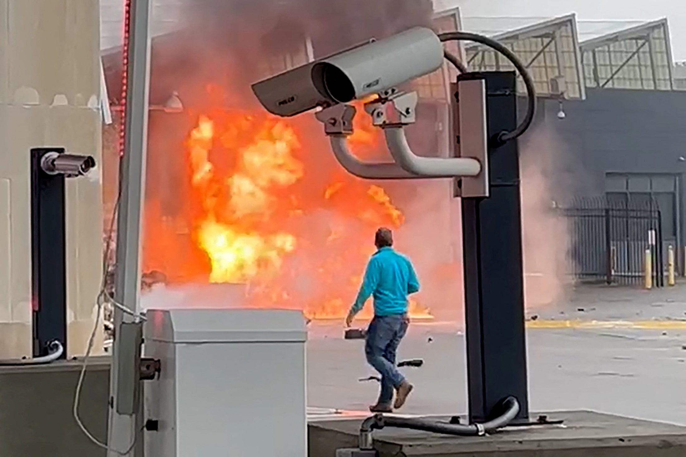 A vehicle burns at the Rainbow Bridge US border crossing with Canada, in Niagara Falls