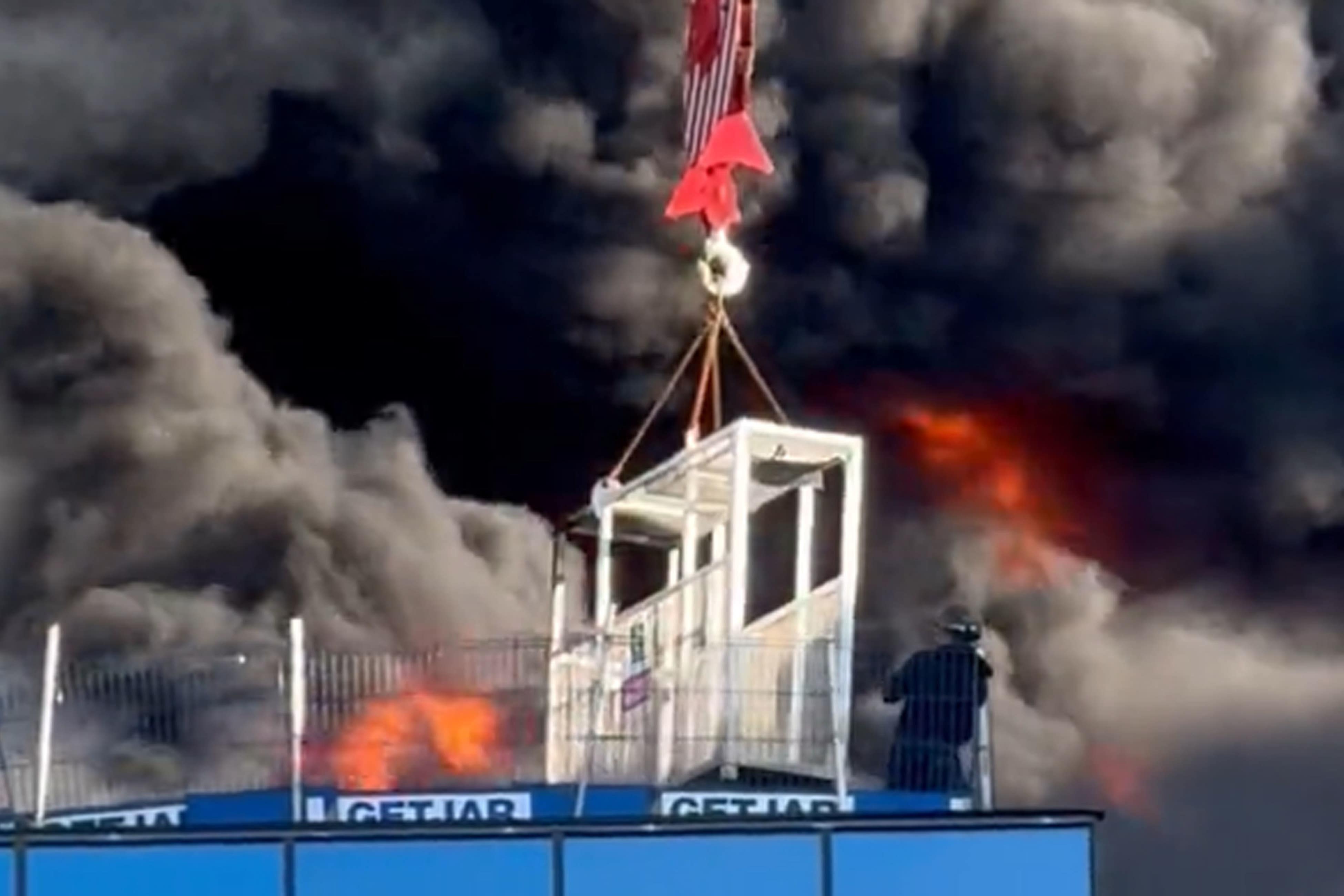 A workman who was trapped on a roof being lifted to safety