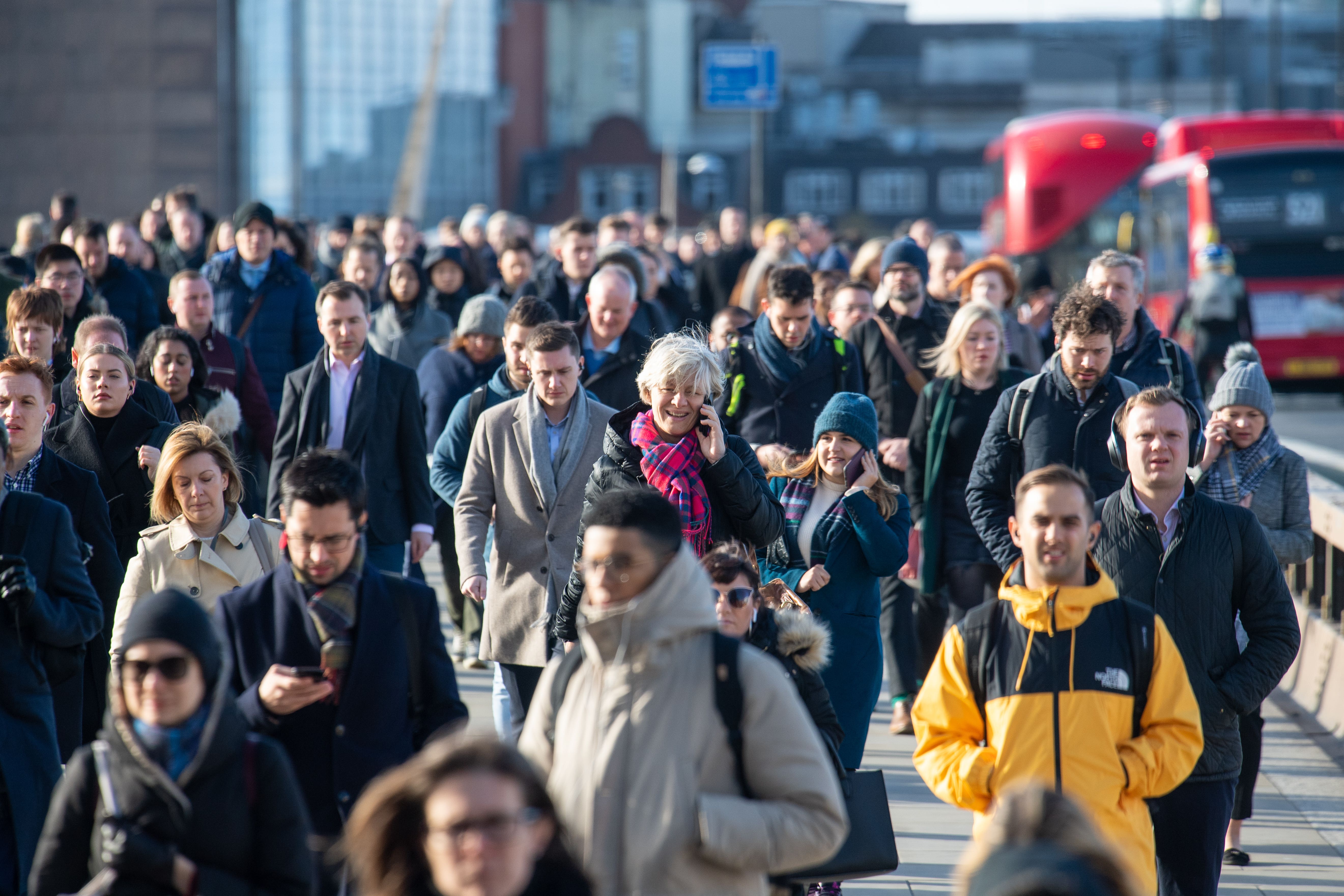 A crowd of people crossing London Bridge