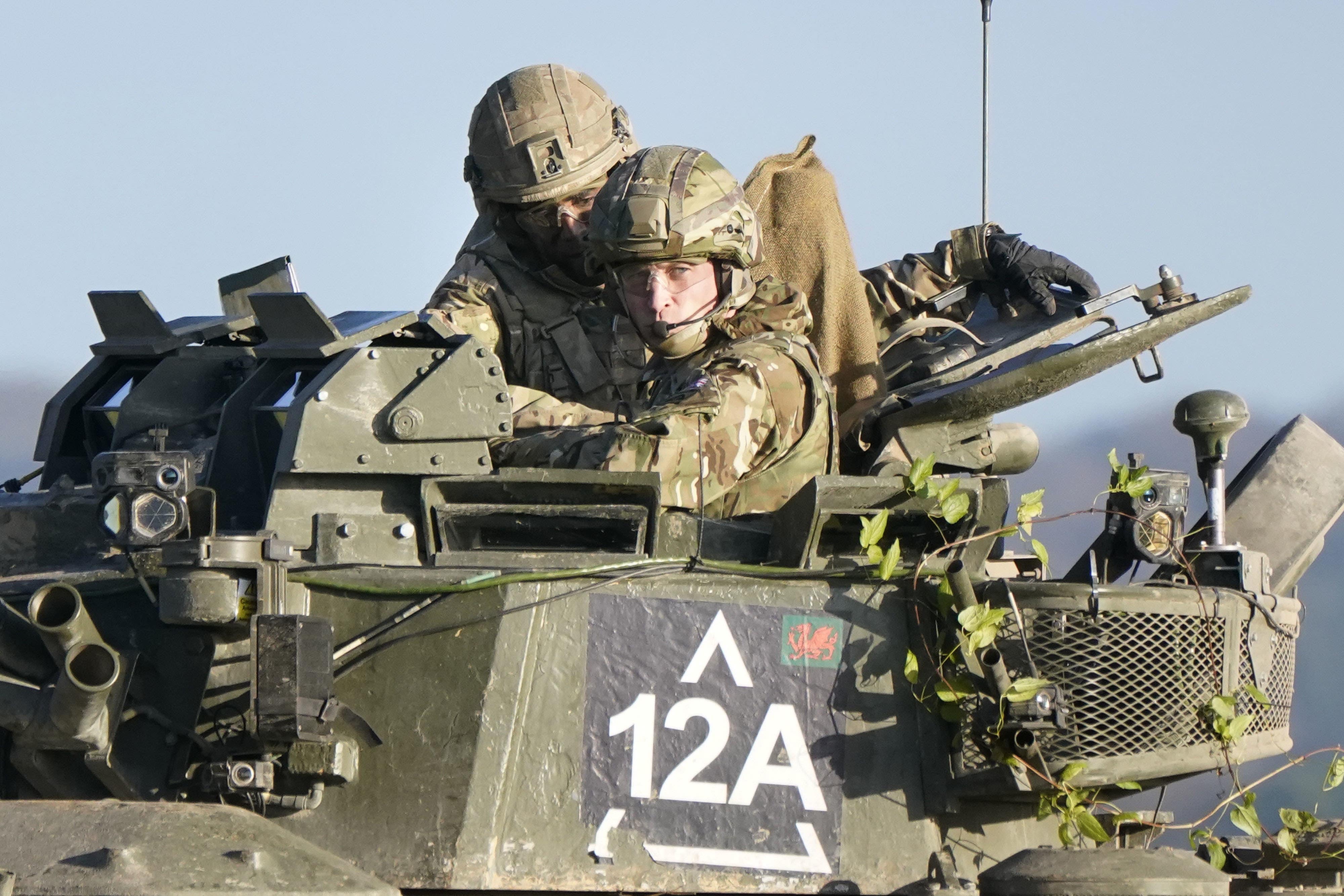 The Prince of Wales, right, rides in an armoured vehicle while on a training exercise on Salisbury Plain (Andrew Matthews/PA)